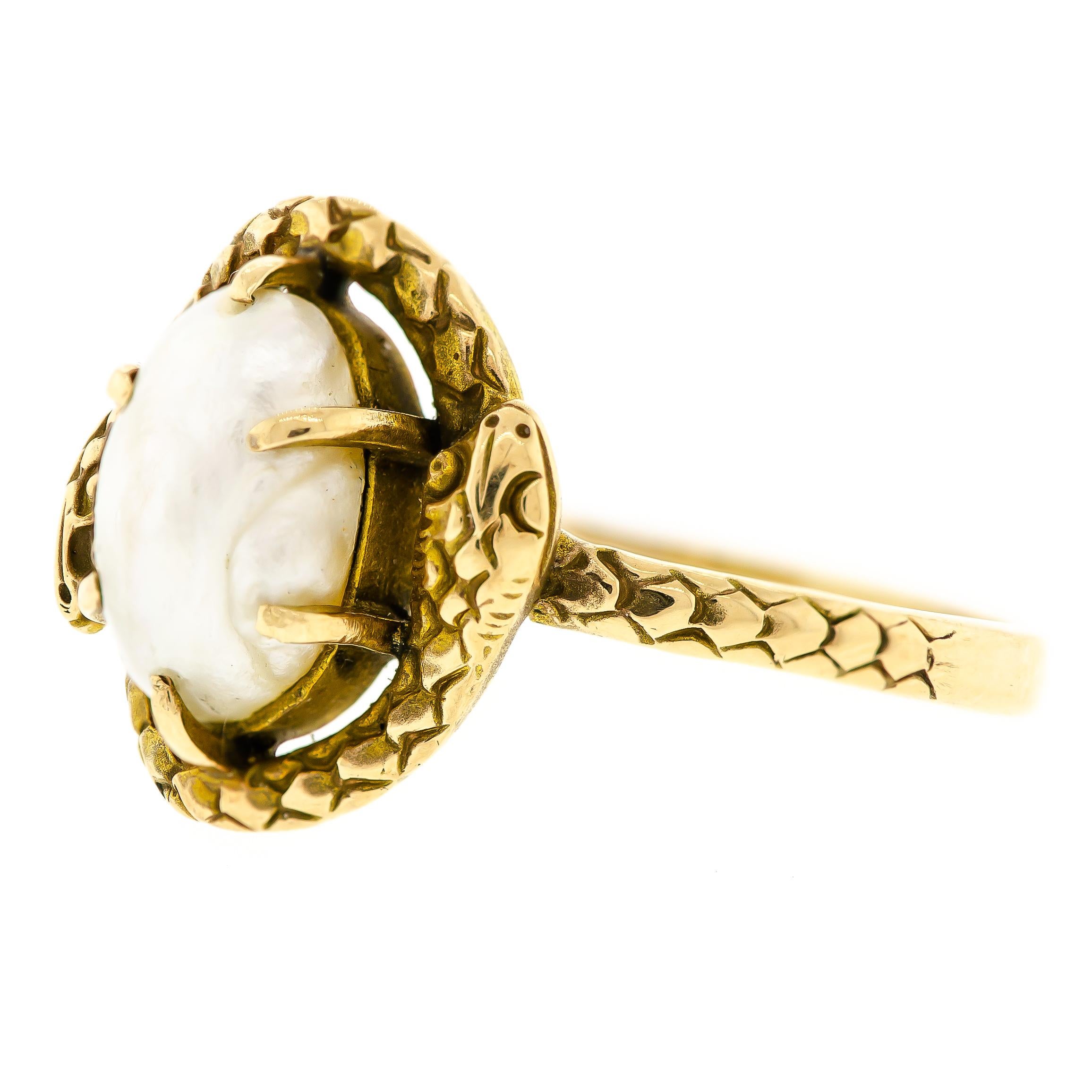 Charming antique pearl and 14kt yellow gold double snake ring centrally set with one baroque pearl prong set framed by  textured scaly double snake all rendered in 14 karat yellow gold.  14K A * makers mark on shank - currently about a size 6 3/4