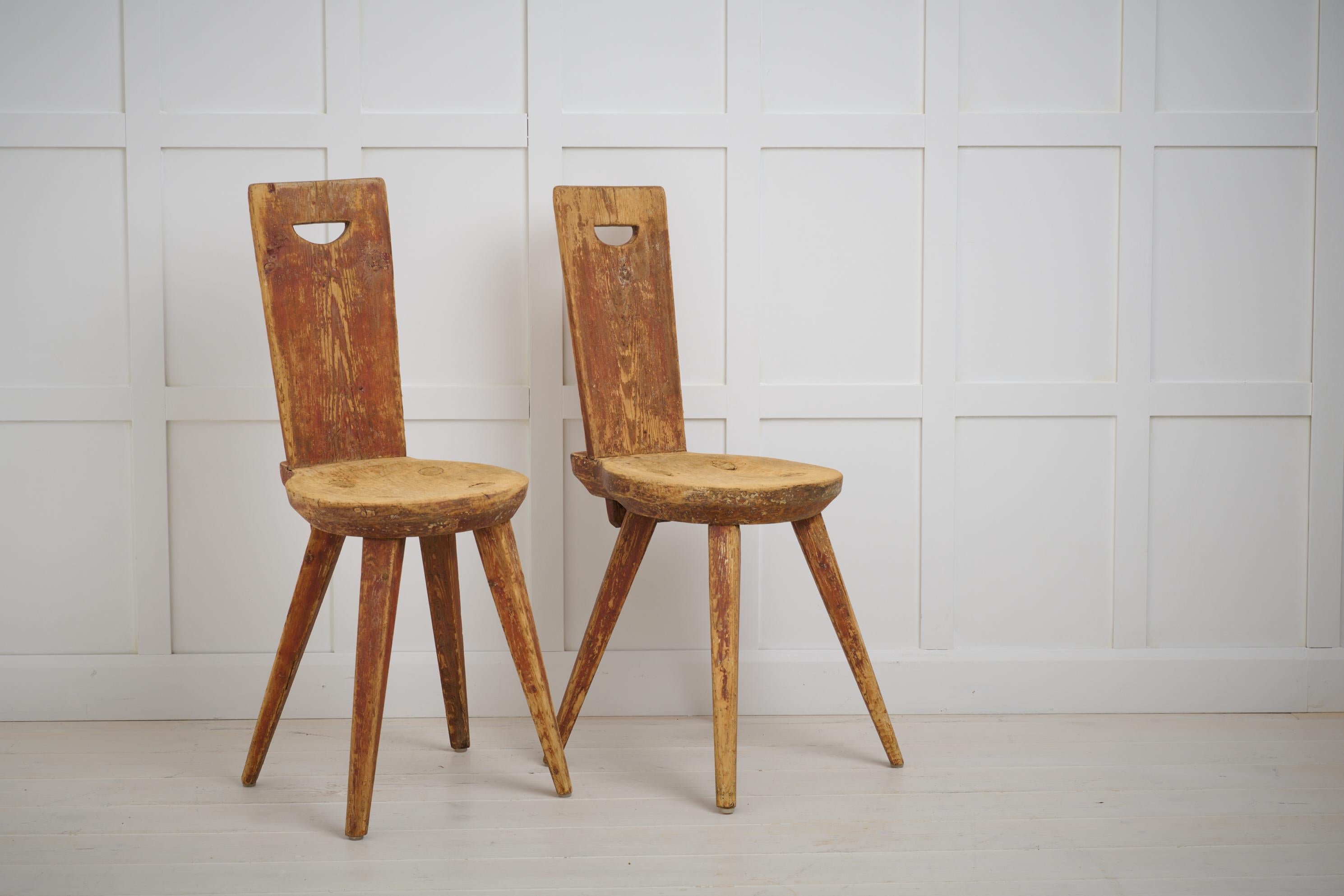 Charming antique primitive chairs in folk art made in northern Sweden. Made by hand in solid pine around the year 1800 which makes them around 220 years old. Original paint which has been worn and distressed so the wood underneath shines through.