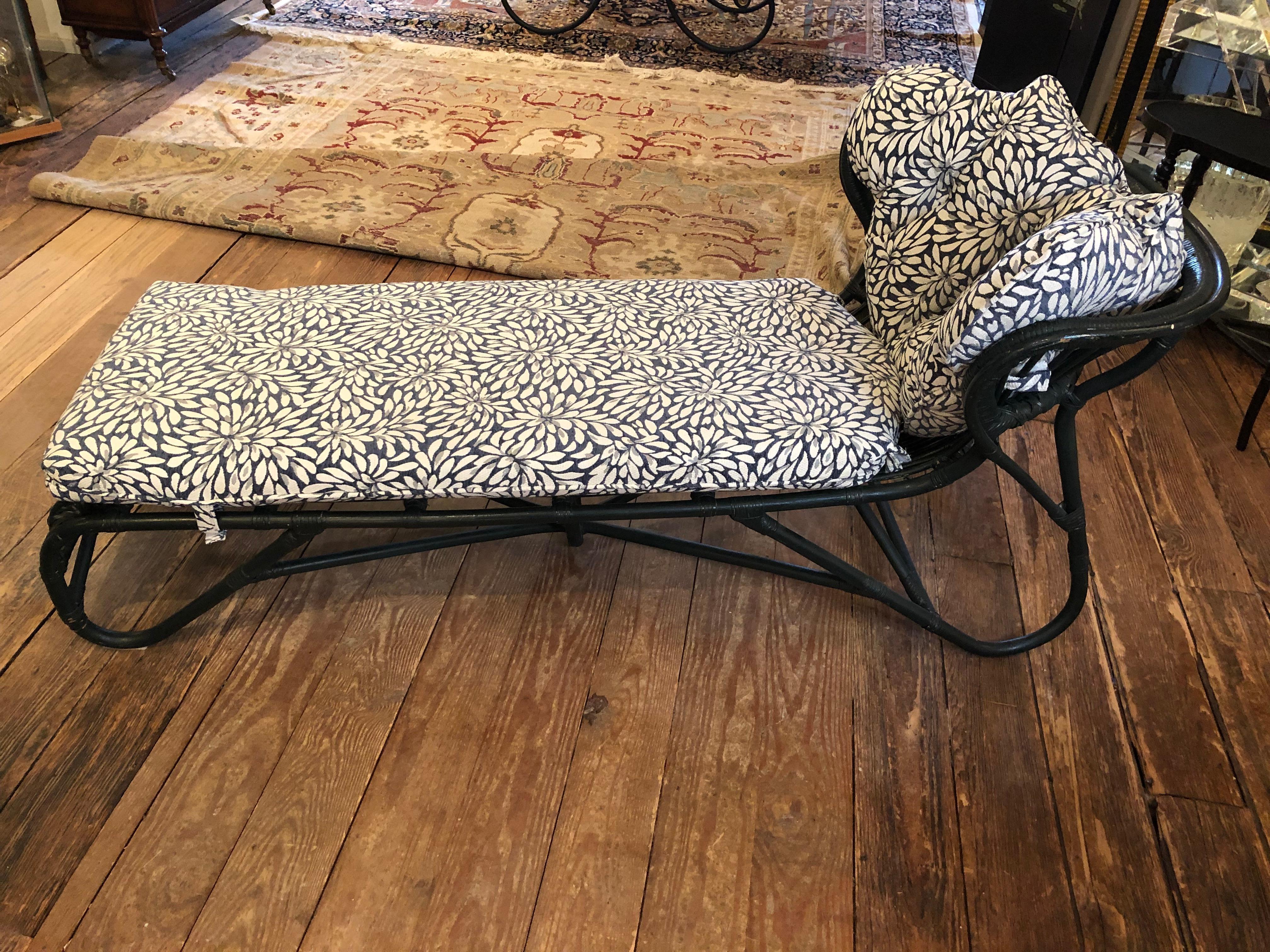 Charming dark green wicker vintage chaise longue with delightful silhouette and brand new custom cushions that velcro in place.  The back cushion is a fabulous tufted clam shape adding a bit of whimsy and rarity.
seat height 15