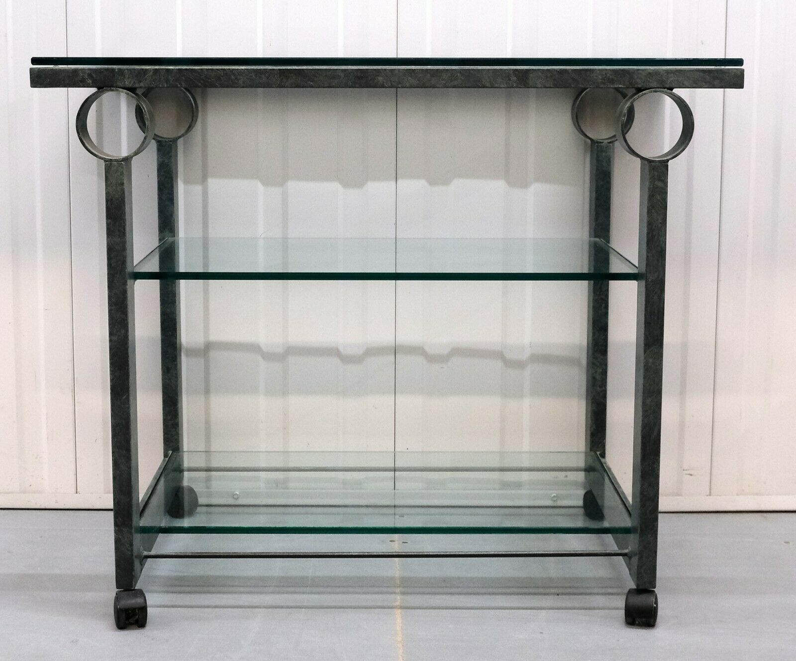 We are delighted to offer for sale this charming art deco glass and iron drinks trolley in very good condition.

The shape of the frame is very sleek and the colour makes a perfect combination for this item. The clear glass is quite thick and
