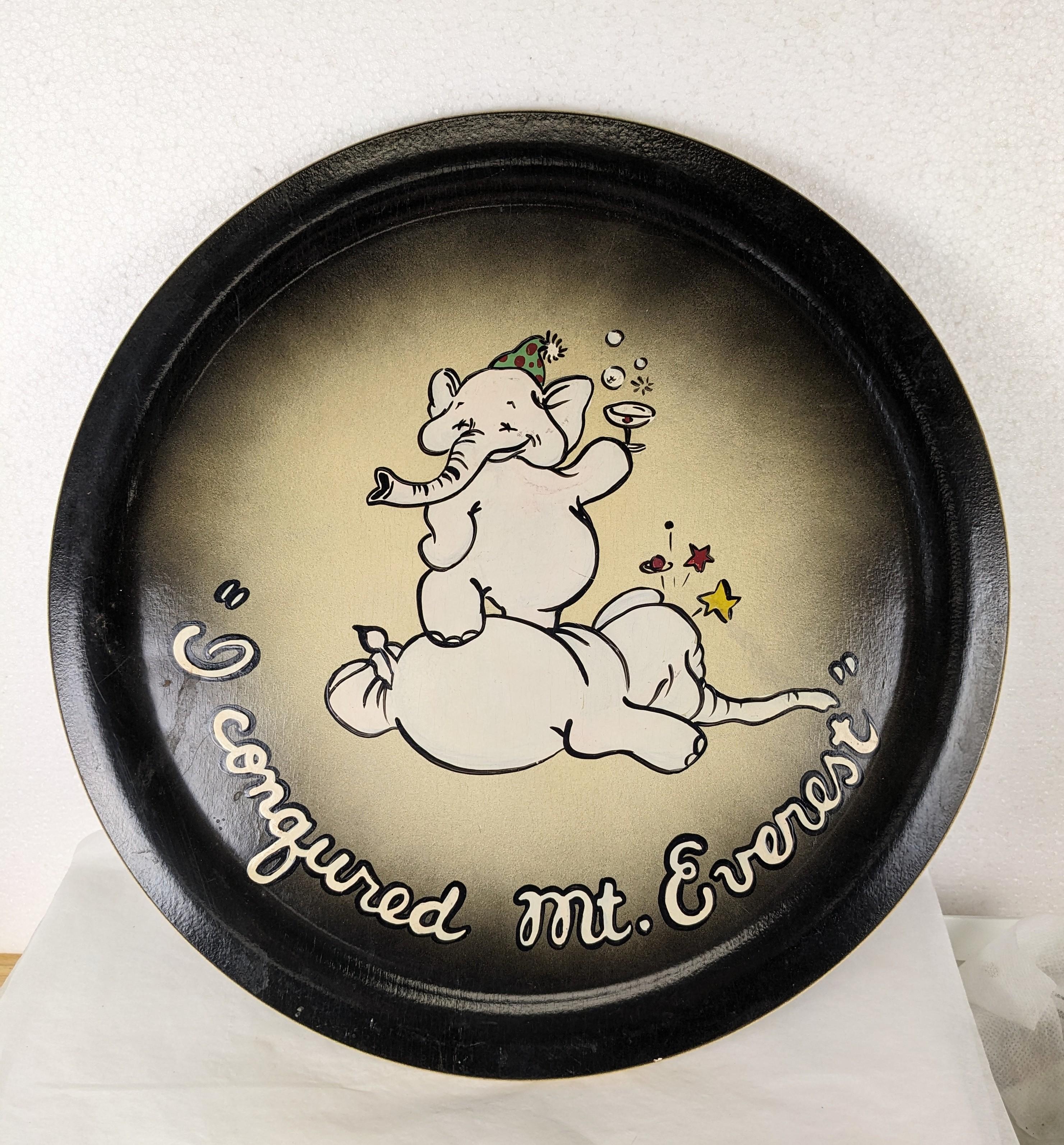 Charming Art Deco Hand Painted Bar Tray from the 1930's. Cartoonish graphics of a inebriated elephant conquering Mt Everest (his pal). Wood base is air brushed first and then over painted, great for display. 
14