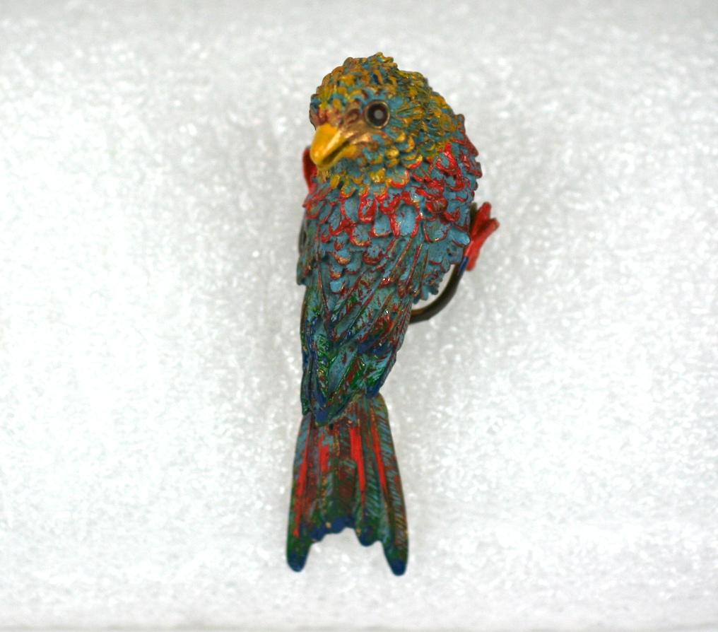 Charming Art Deco Perched Bird Clip from the 1930's. Vibrant polychrome enamels are used on this adorable bird with his head turned back, with ruby paste eyes.
Designed to be perched high on a shoulder as a guardian/companion. 
2.5