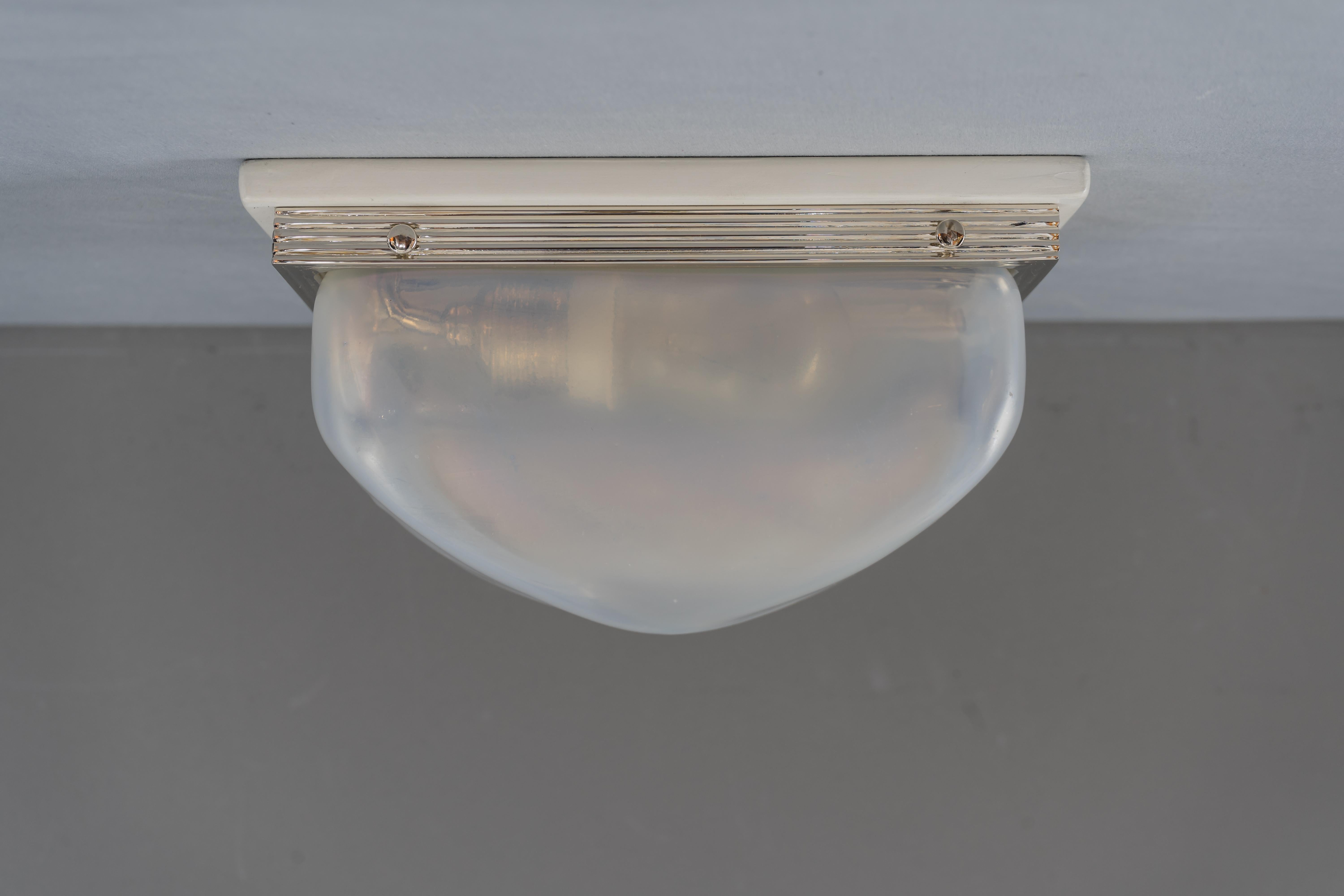 Charming Art Deco wall or ceiling lamp vienna circa 1920s
Brass nickel-plated
White painted wood plate
original opaline glass shade.