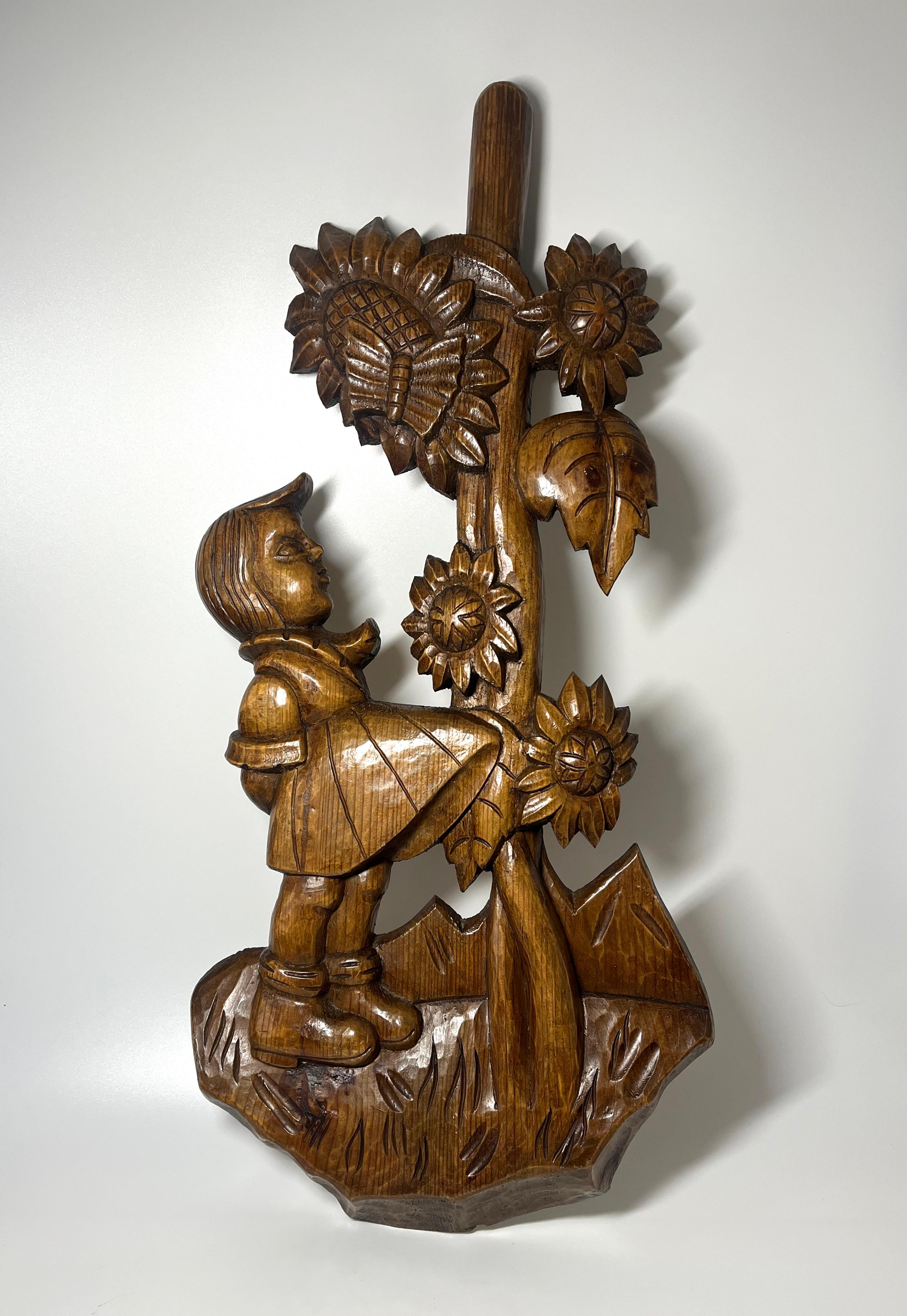 Absolutely charming, large wood carving of a young Bavarian girl and sunflower wall decoration
This substantial wall hanging is two feet in length, has a rich patina and super hand carved folk art detailing
Hanging ring on reverse
Circa