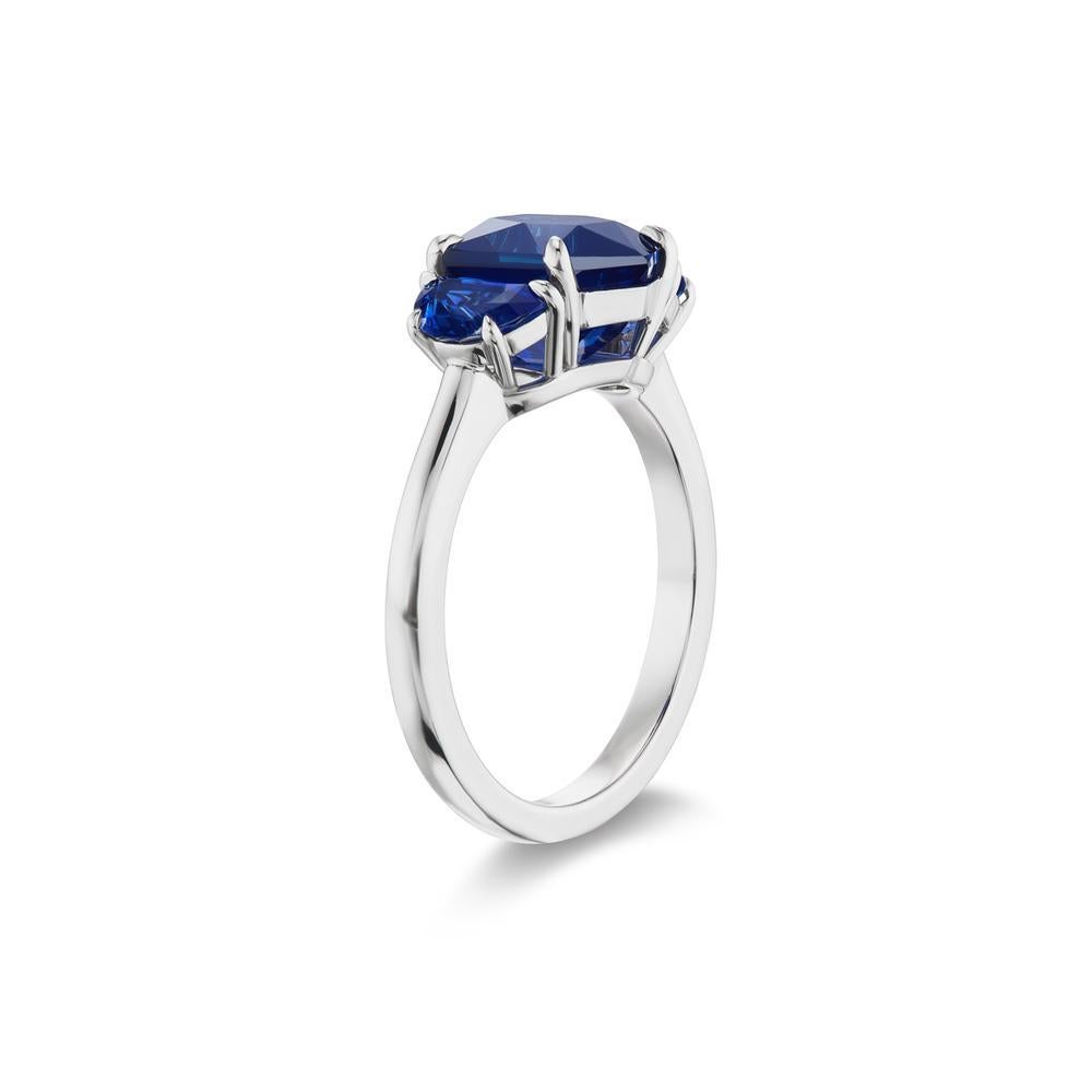 CHARMING BLUE SAPPHIRE
RING
This elegant blue sapphire three stone ring so unique, its claw set stones
are flanked by glimmering half-moon sapphires, displaying a
mesmerizing harmony of blue dazzle
Item: # 03843
Metal: Platinum
Lab: Guild