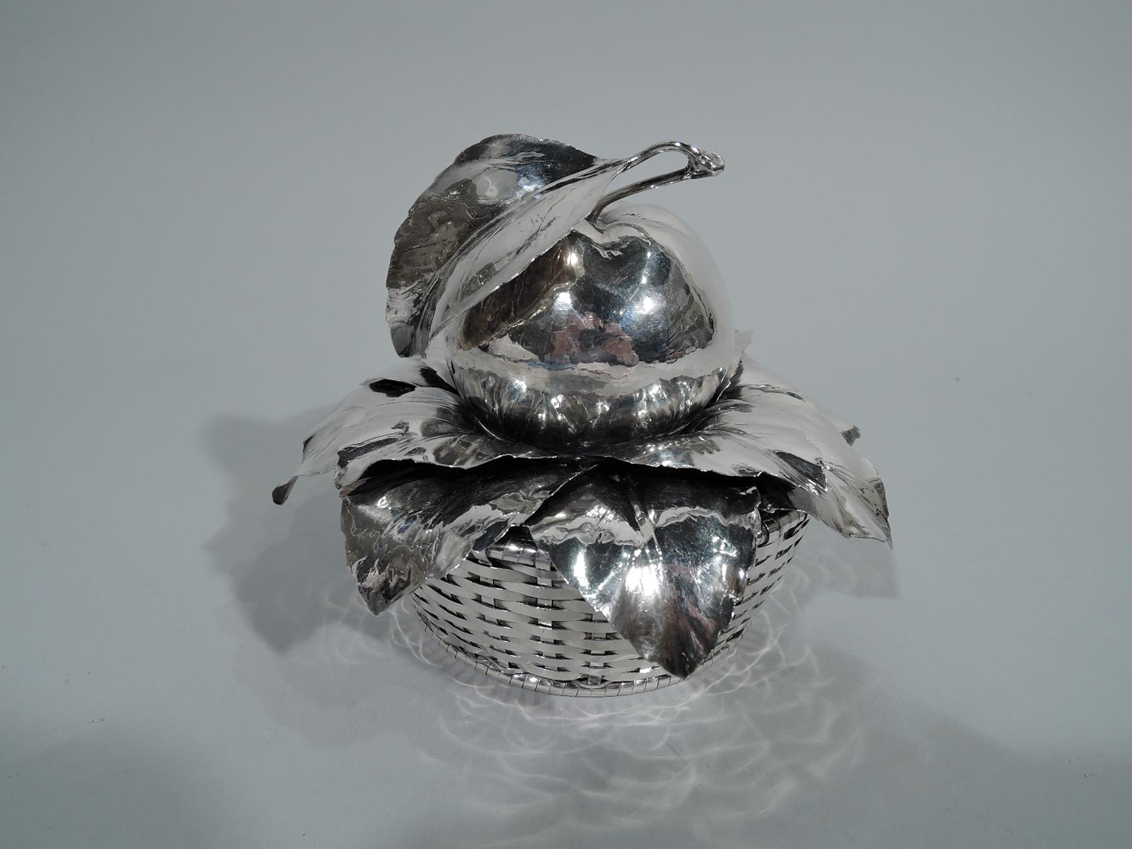 Charming sterling silver basket. Made by Buccellati in Milan. Solid well and open woven sides. Cover in form of overlapping leaves mounted to open circular frame. Oversized apple finial – a realistic fruit with leafy stem. Hallmark (1968 to