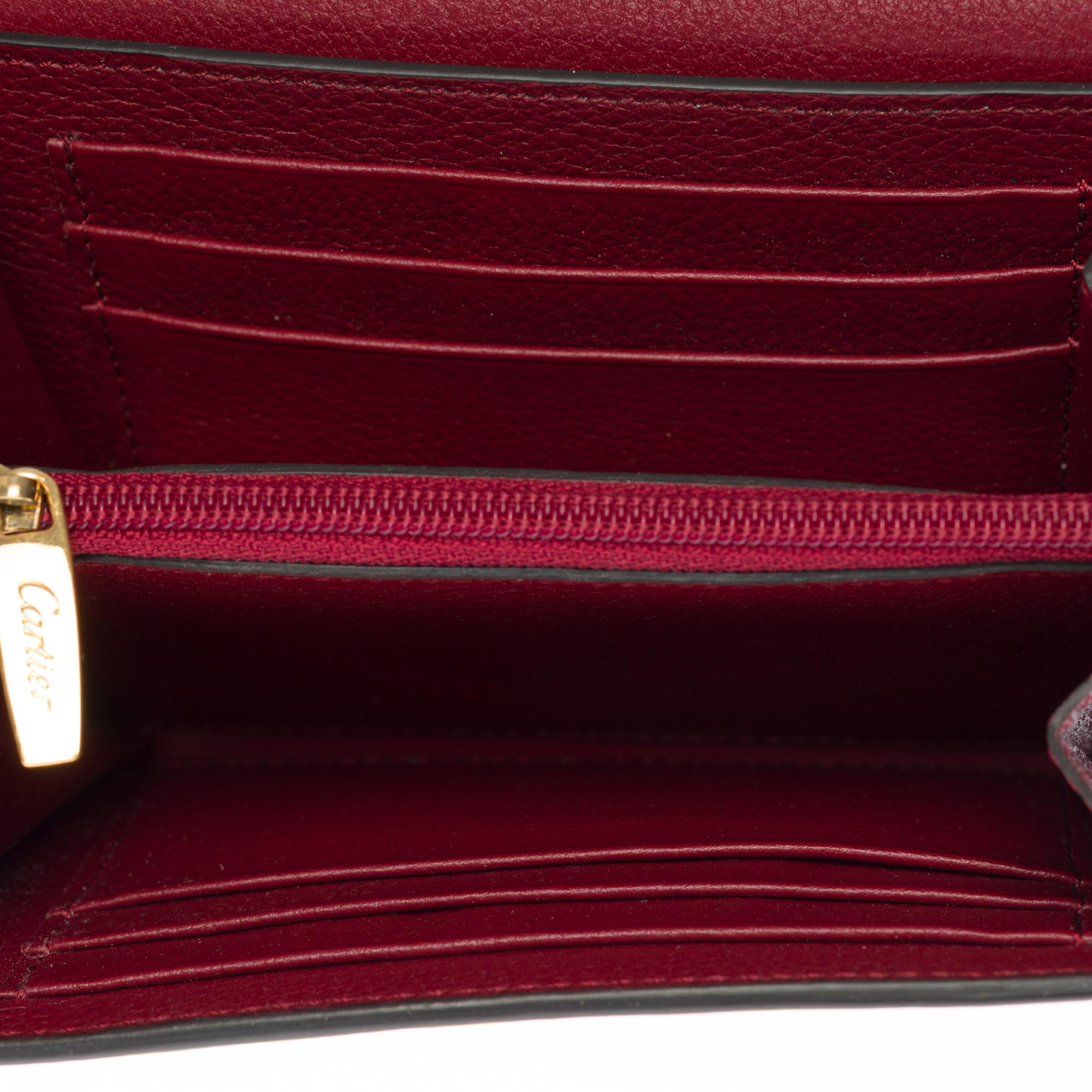 Charmante Cartier-Brieftasche aus bordeauxfarbenem Leder mit Goldbeschlägen 2