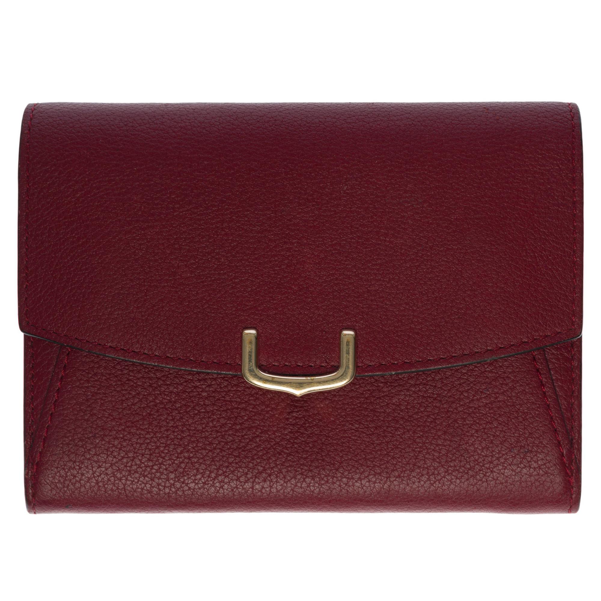Charmante Cartier-Brieftasche aus bordeauxfarbenem Leder mit Goldbeschlägen