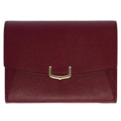 Charming Cartier wallet in burgundy leather with gold hardware