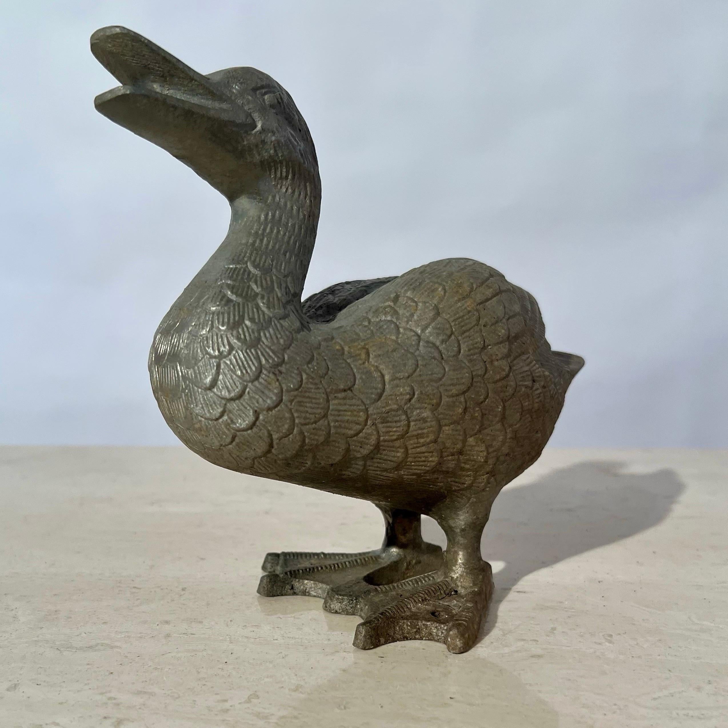 We offer to you this cheerfull addition for your home or garden! In the form of a young duck, his expression is as if he is a very happy fellow and will share his joy freely with you! This whimsical vintage cast metal  sculpture would be equally