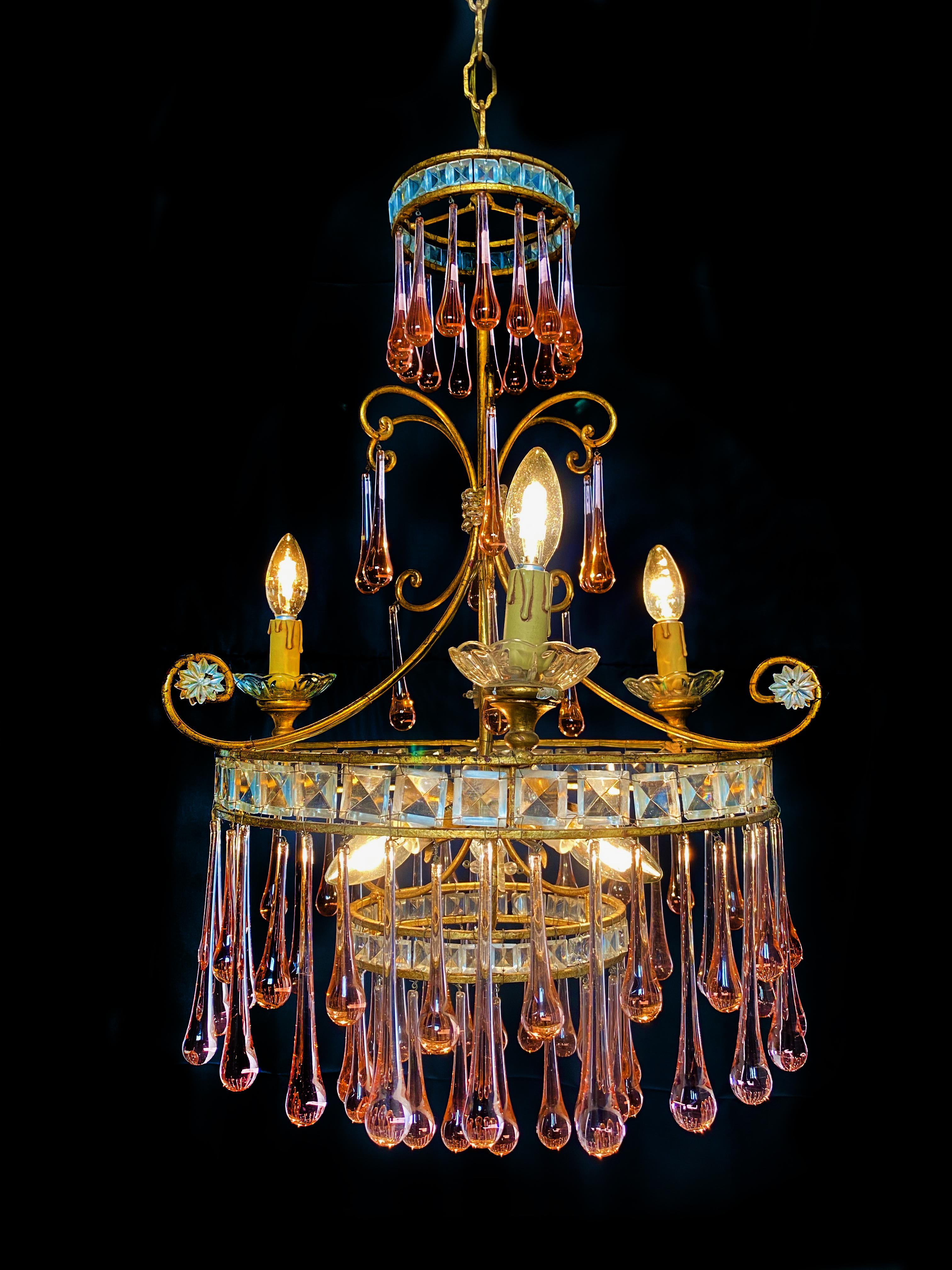 Elegant Venetian chandelier. Dozens of ambra drops hang from the golden canopy. Six small lights.
  
