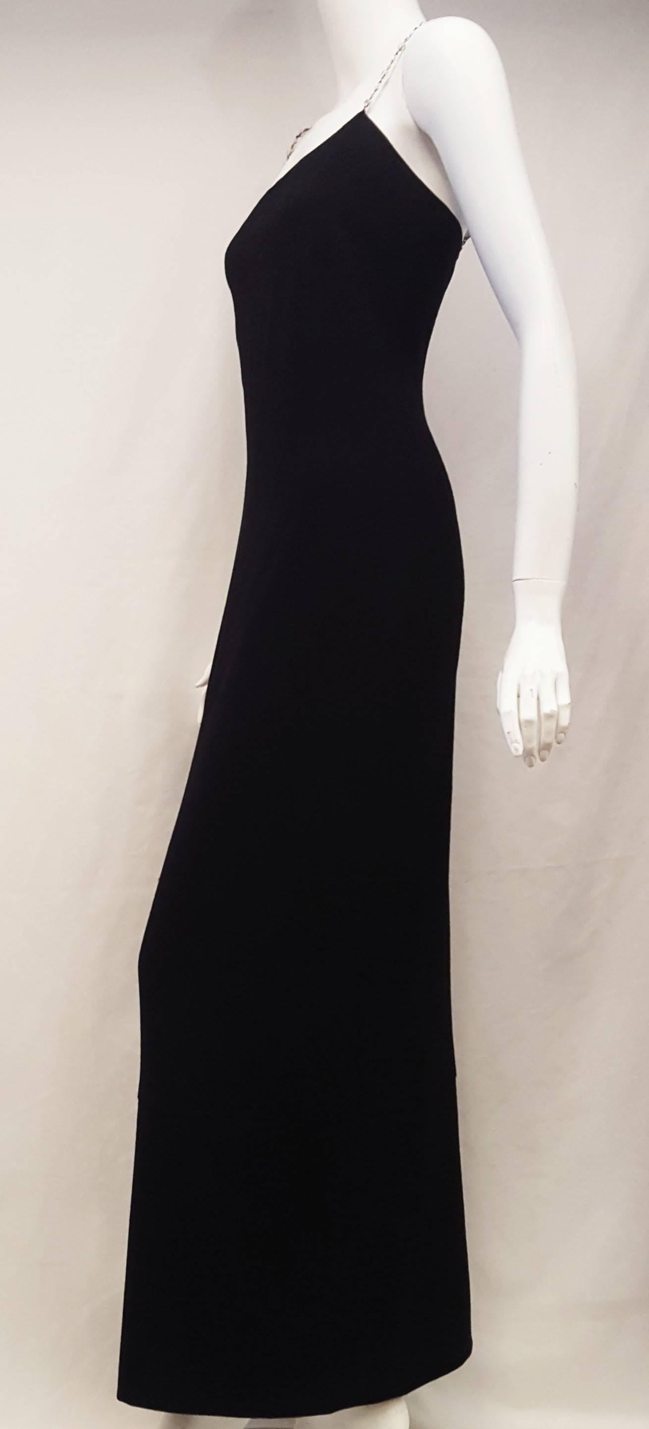 Chanel black wool dress with crystal gripoix straps long dress makes a statement for many occasions!  It will stand out much more than your typical LBD.  The gripoix crystal is set in an elegant yet sturdy silver tone chain.  The hidden zipper is