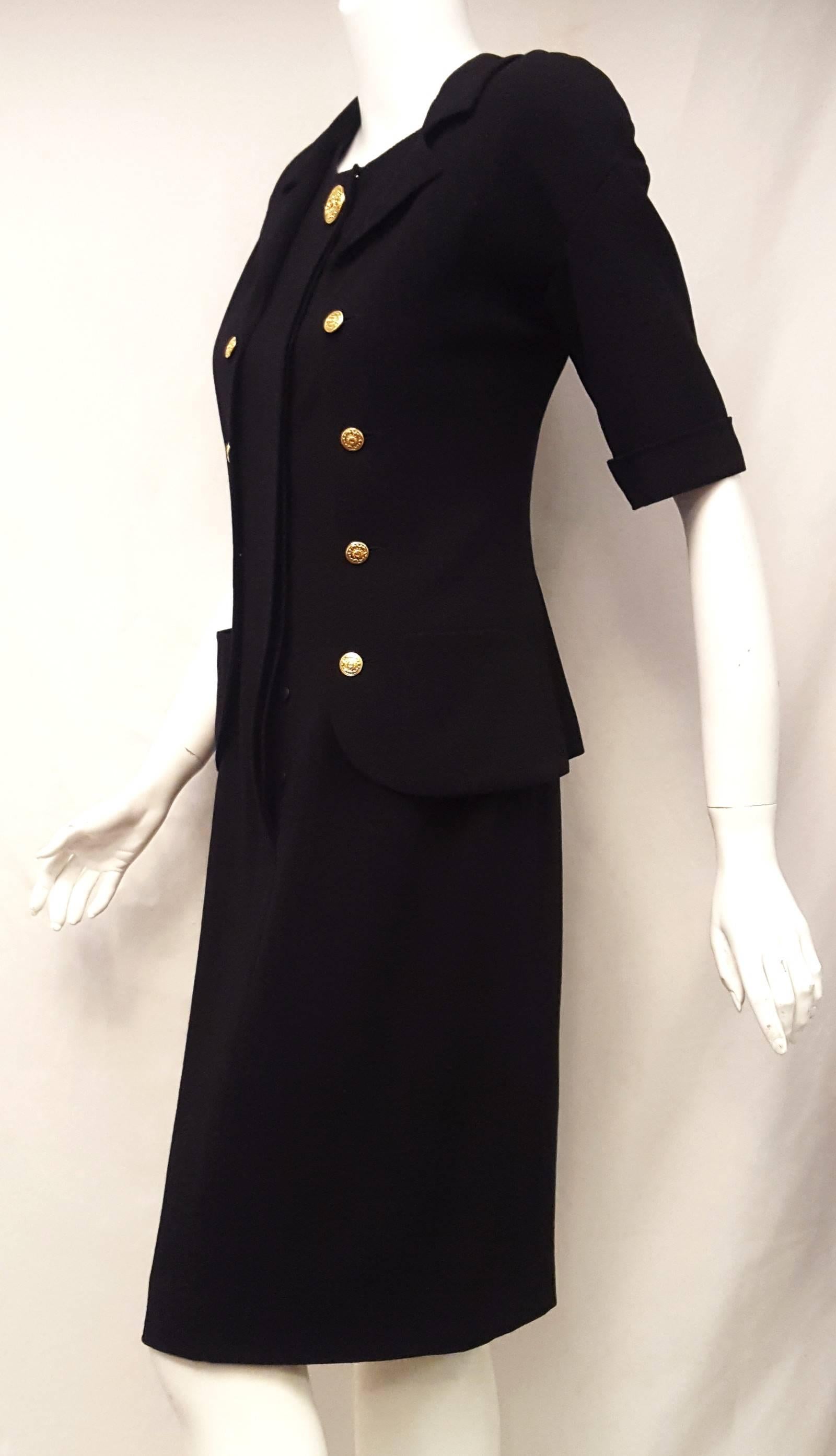 This Chanel black notch collar dress resembles a two piece suit with its faux jacket style.  The jacket does not detach even though it contains 8  goldtone Chanel buttons & buttonholes at each side of front hidden closure with one large Chanel gold