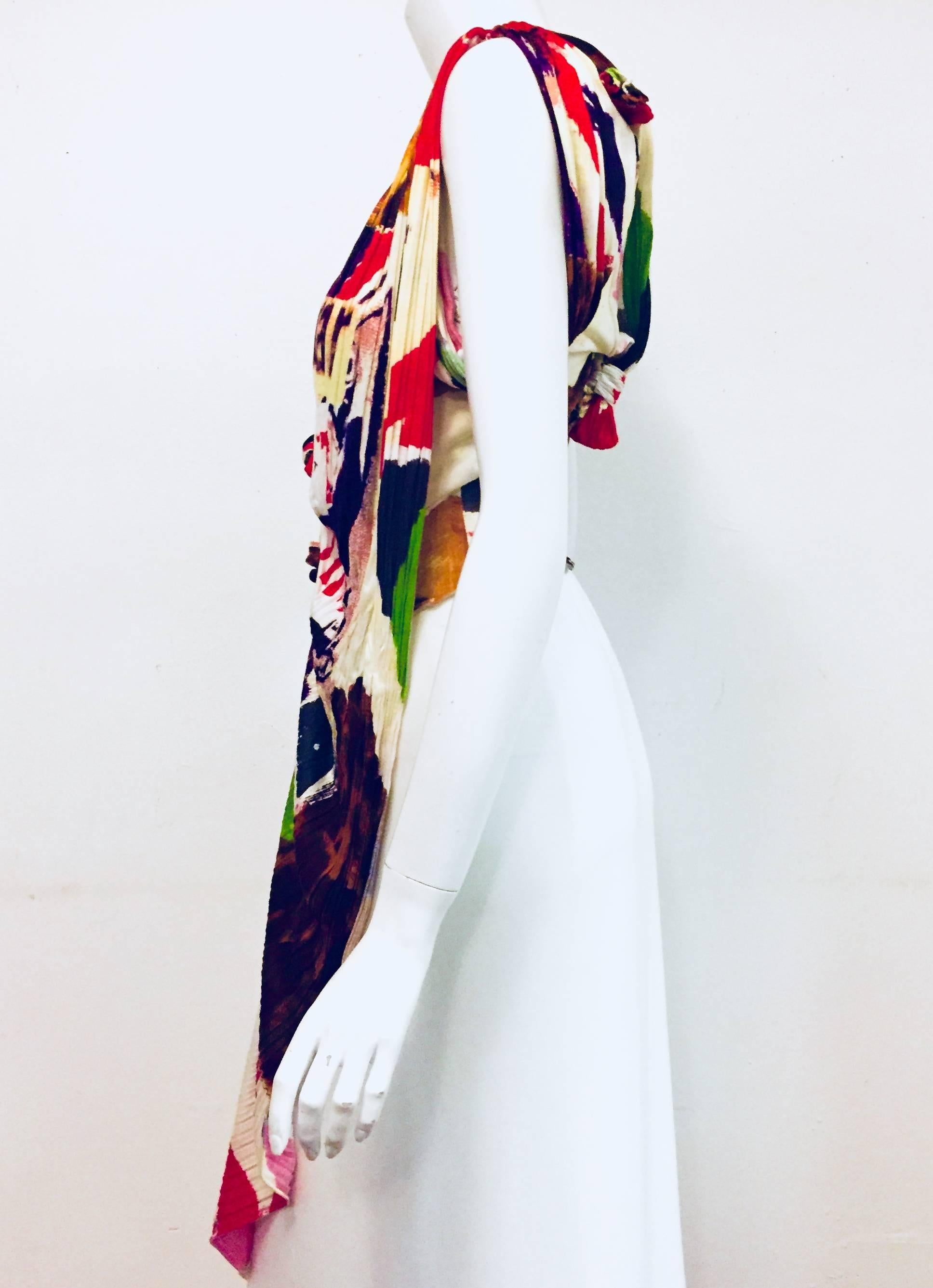 Christian Dior multi color mixed print top featuring different lengths in front and at back.  This avant garde V neck top is sleeveless and it has two tuxedo style tails for added enhancement.  The fabric has been accordion pleated in certain areas,