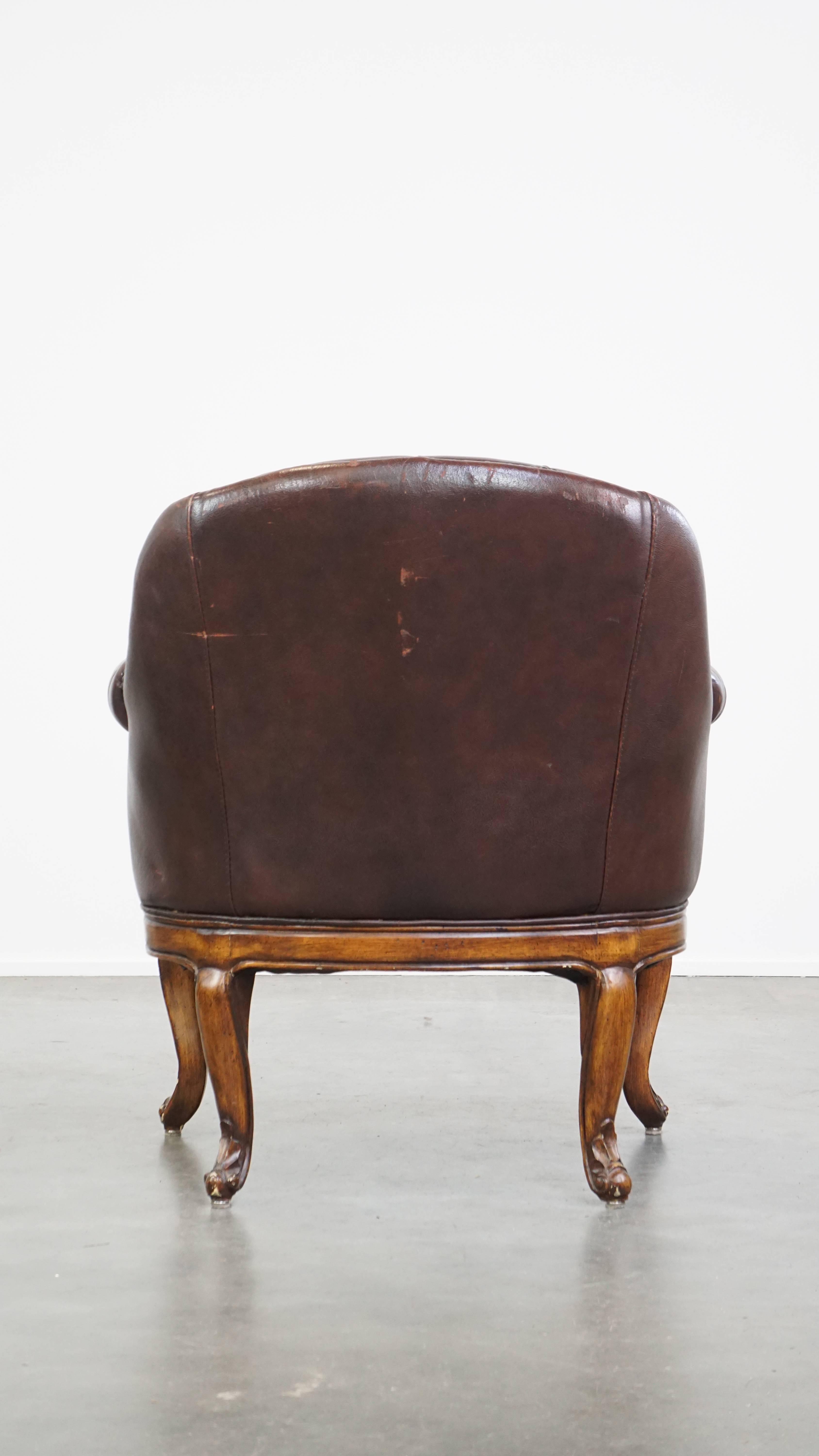 Hand-Crafted Charming, classic cow leather English chesterfield armchair with elegant legs For Sale