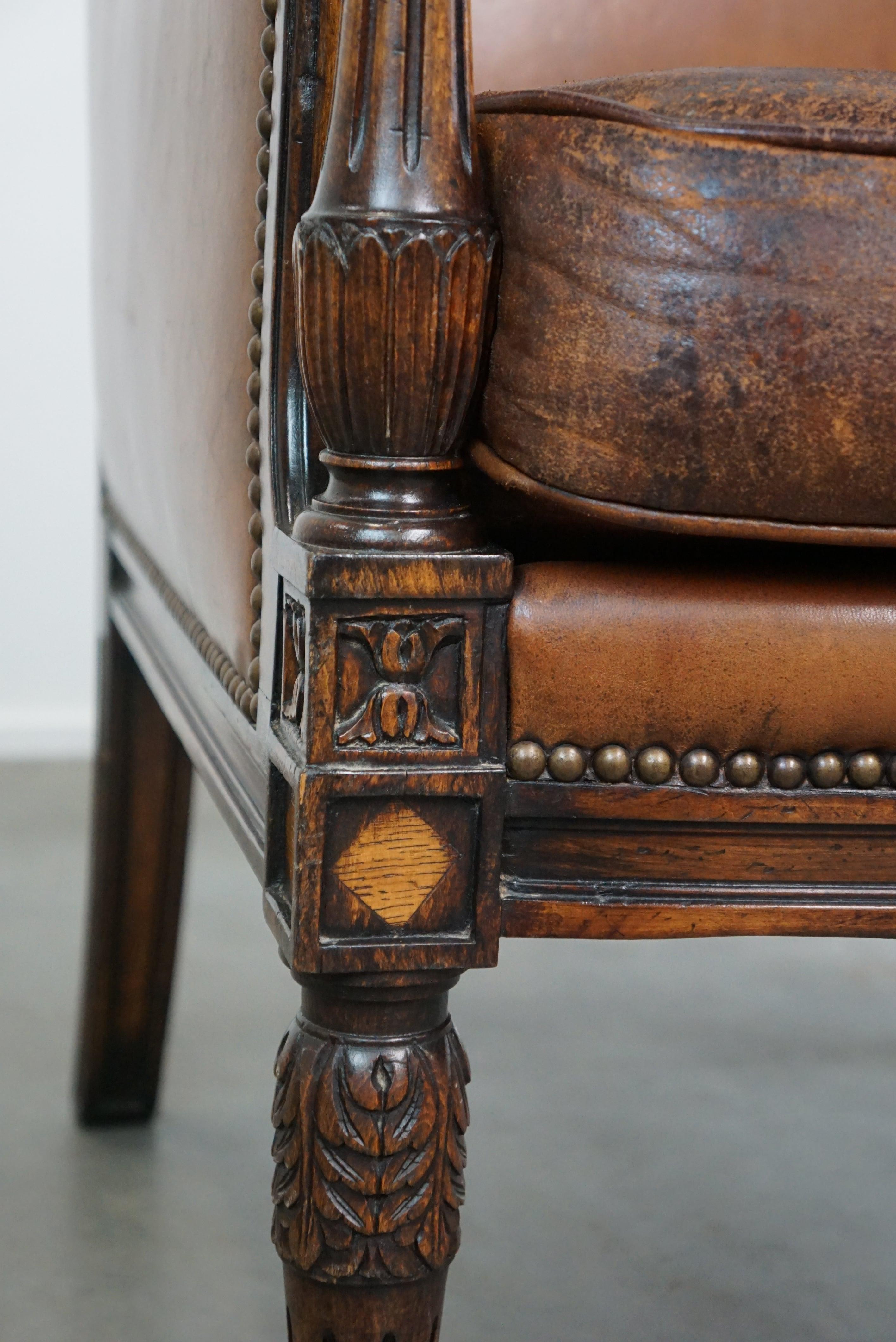 Charming classic sheep leather armchair with wood carving and a nice patina For Sale 3