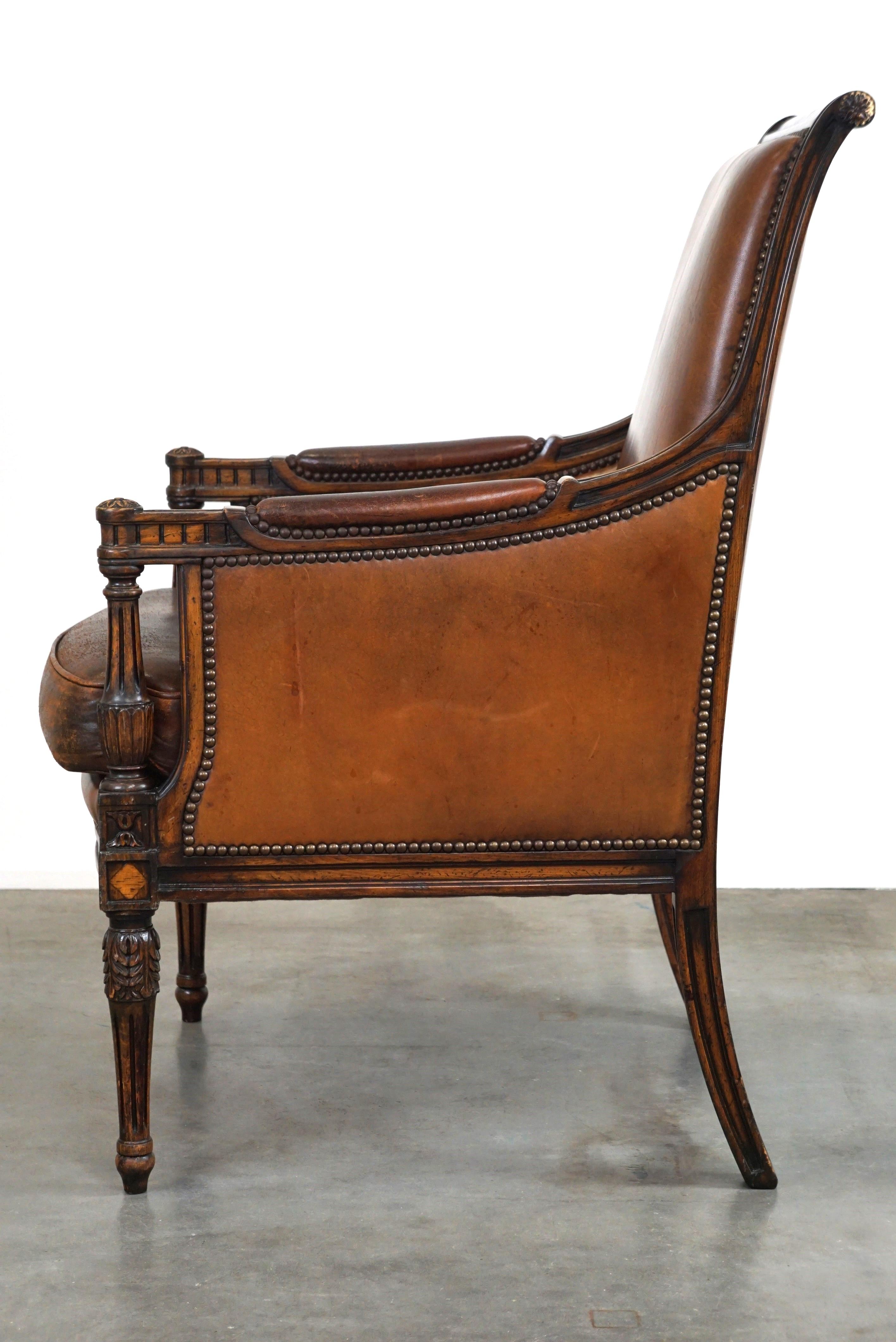Charmant fauteuil classique en cuir de mouton avec sculptures en bois et belle patine. Bon état - En vente à Harderwijk, NL