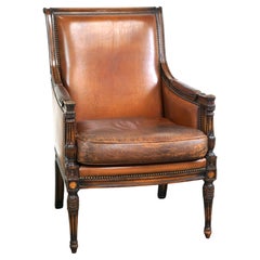 Charming classic sheep leather armchair with wood carving and a nice patina