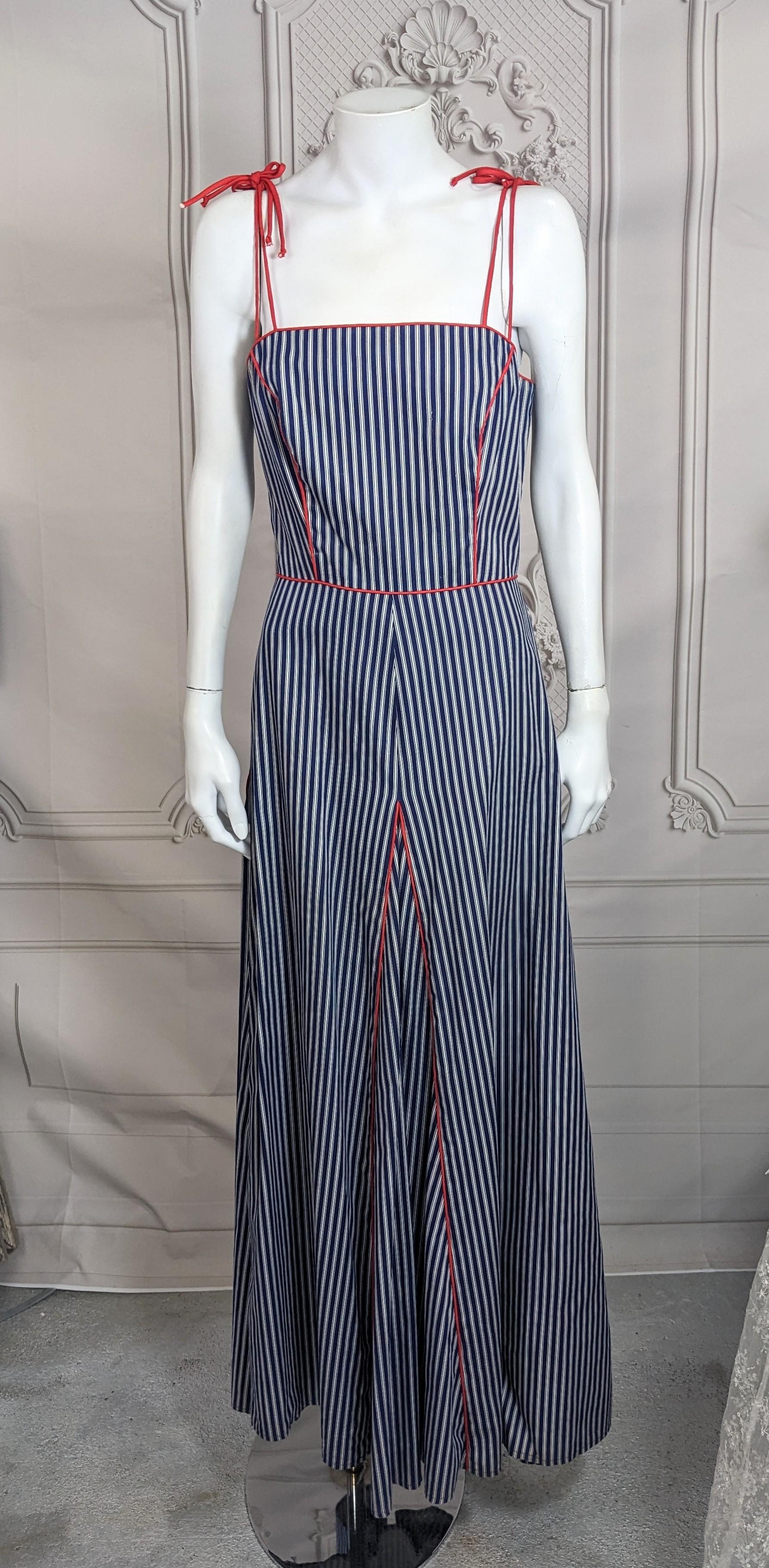 Charming Cotton Ticking Maxi Summer dress from the 1970's retailed by Saks Fifth Ave. piped in contrasting red bias cord throughout. Godet panels of striped ticking open below the hip with red trim which adds a nice fullness to the hem. Back zip