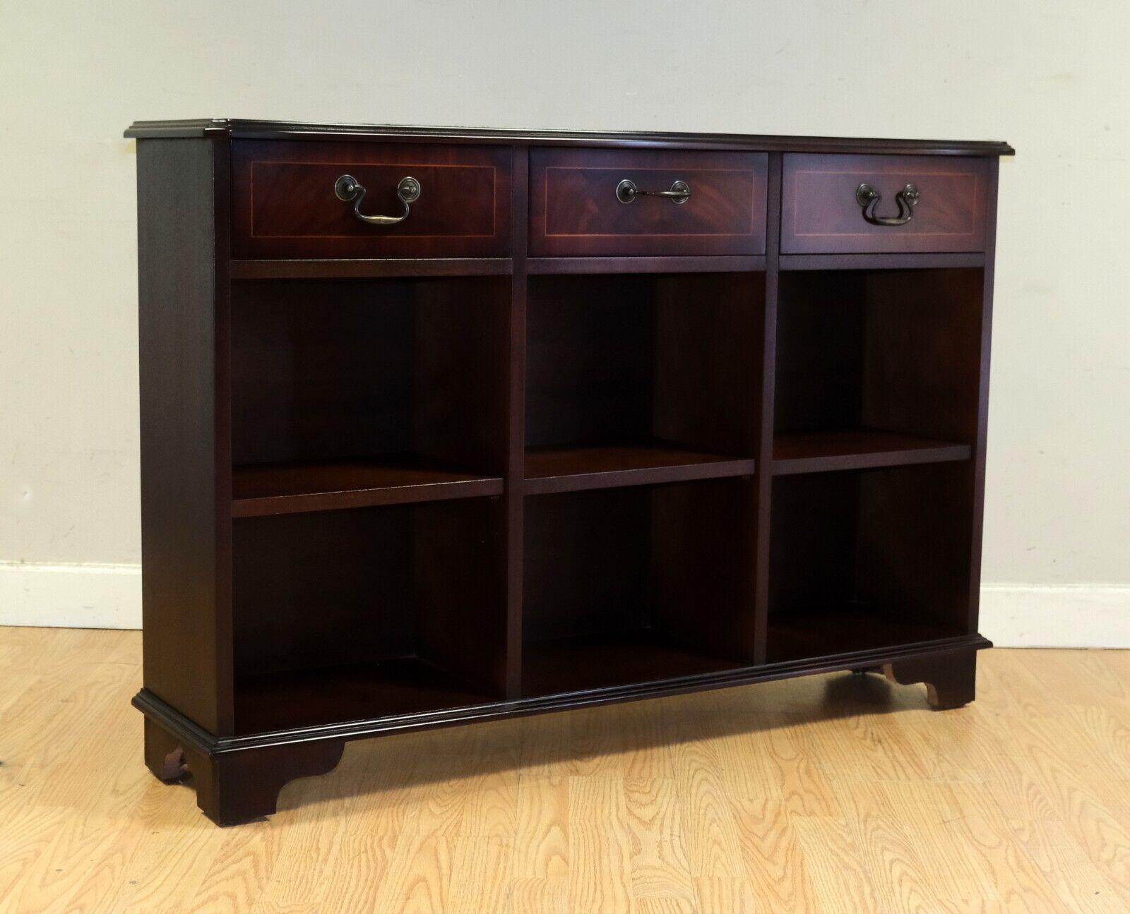 We are delighted to offer for sale this charming dark brown Mahogany low bookshelf sideboard with three drawers and shelves.

This well made and useful piece would add style to any room around your house and it is ideal for small spaces, as it does