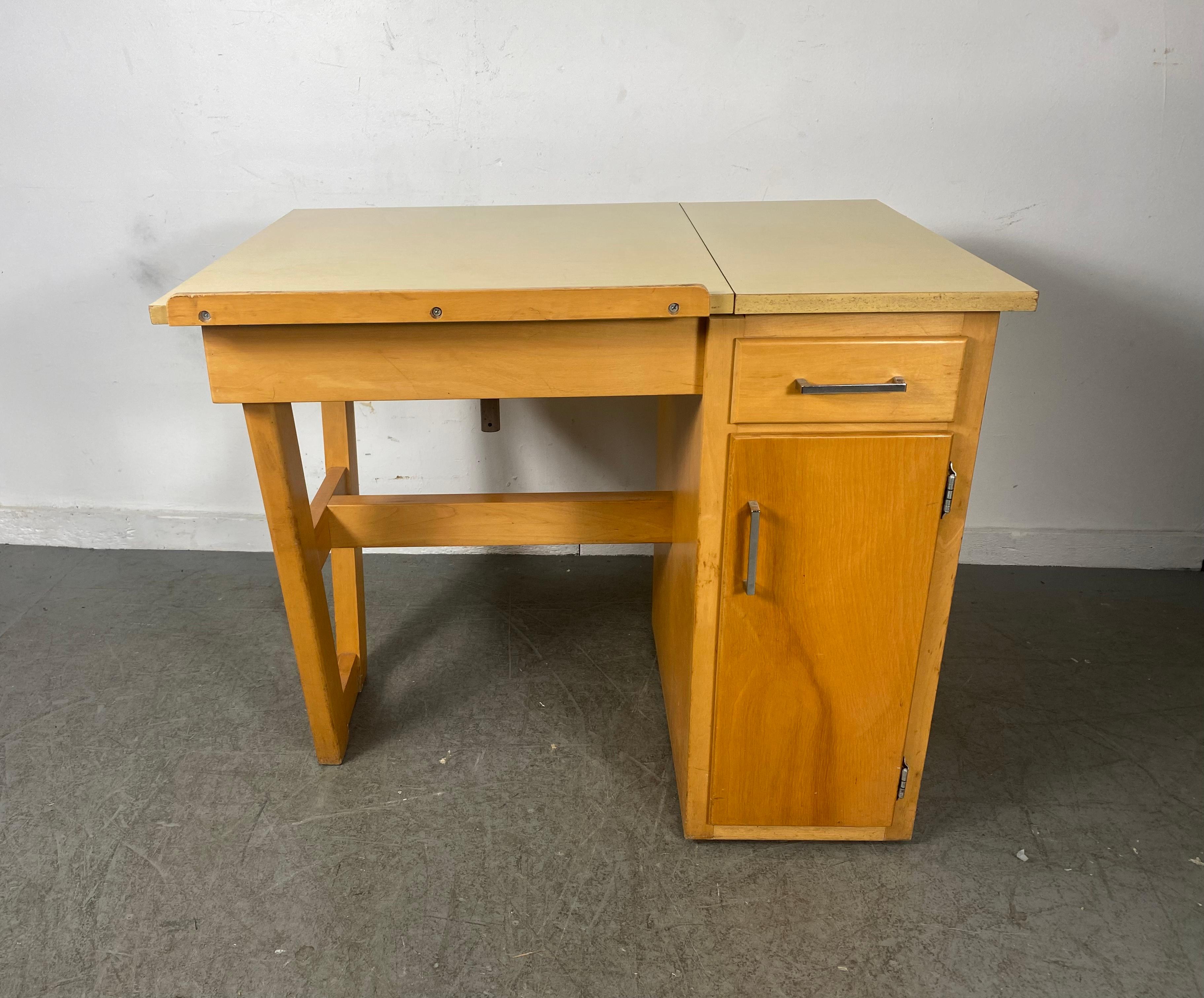 Charming ,diminutive desk / drafting table,,Classic Modernist Design.. Art Storage .. Wonderful design,, Adjustable top,, Drawer and storage cubbies.. Nice original condition,,Hand delivery avail to New York City or anywhere en route from Buffalo NY