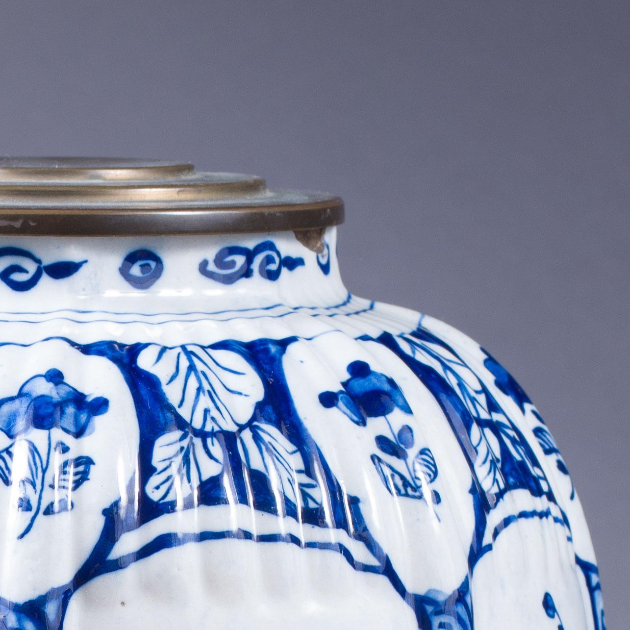 Charming early 19th century Delft cobalt blue and white vase decorated with four repeated hand-painted scenes of parrots perched above whimsical buildings and bridges over waterways with figures walking.
The Netherlands, circa 1820

Measures: