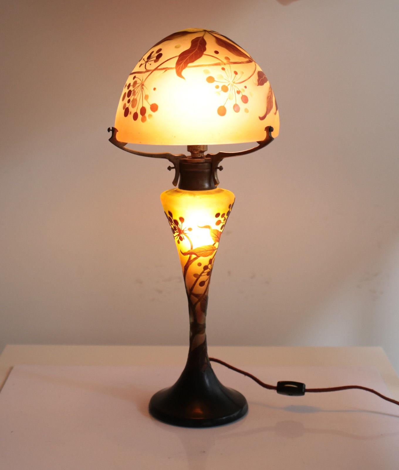 A charming Emile Galle art glass 3-layer multi-color table lamp, fourth quarter of the 19th century. Decorated brown flowers over a soft pink, peach, and green base. Both the shade and base are signed. Weight Approx., 5 lbs 

Measures Approx., 7