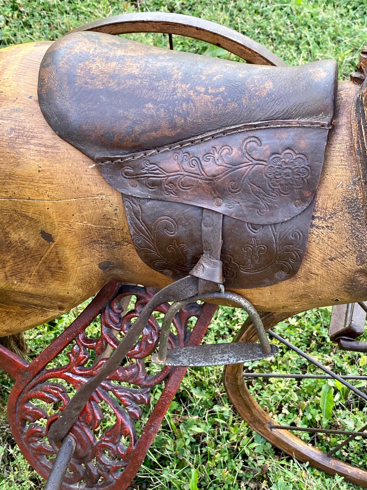 A charming reproduction horse bicycle having carved wood, leather saddle, iron wheels, glass eyes and rope tail. Child size, functional, but we suggest it more as a decorative accessory for a family room or such.
Measure: Seat height 22.