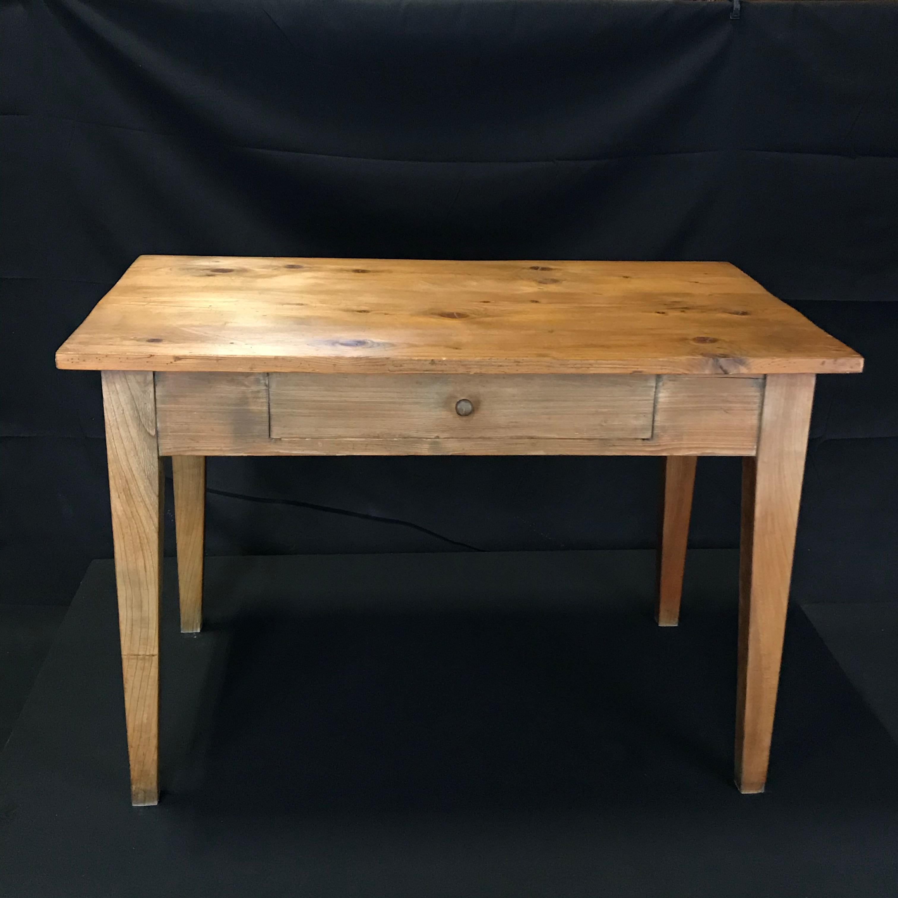 This French Provincial country pine table could serve many uses: as an intimate dining table, a desk, a side table, console, or could be cut down for a beautiful coffee table. Classic design, purchased in Lyon, France.
 H skirt 22.75
#1945.