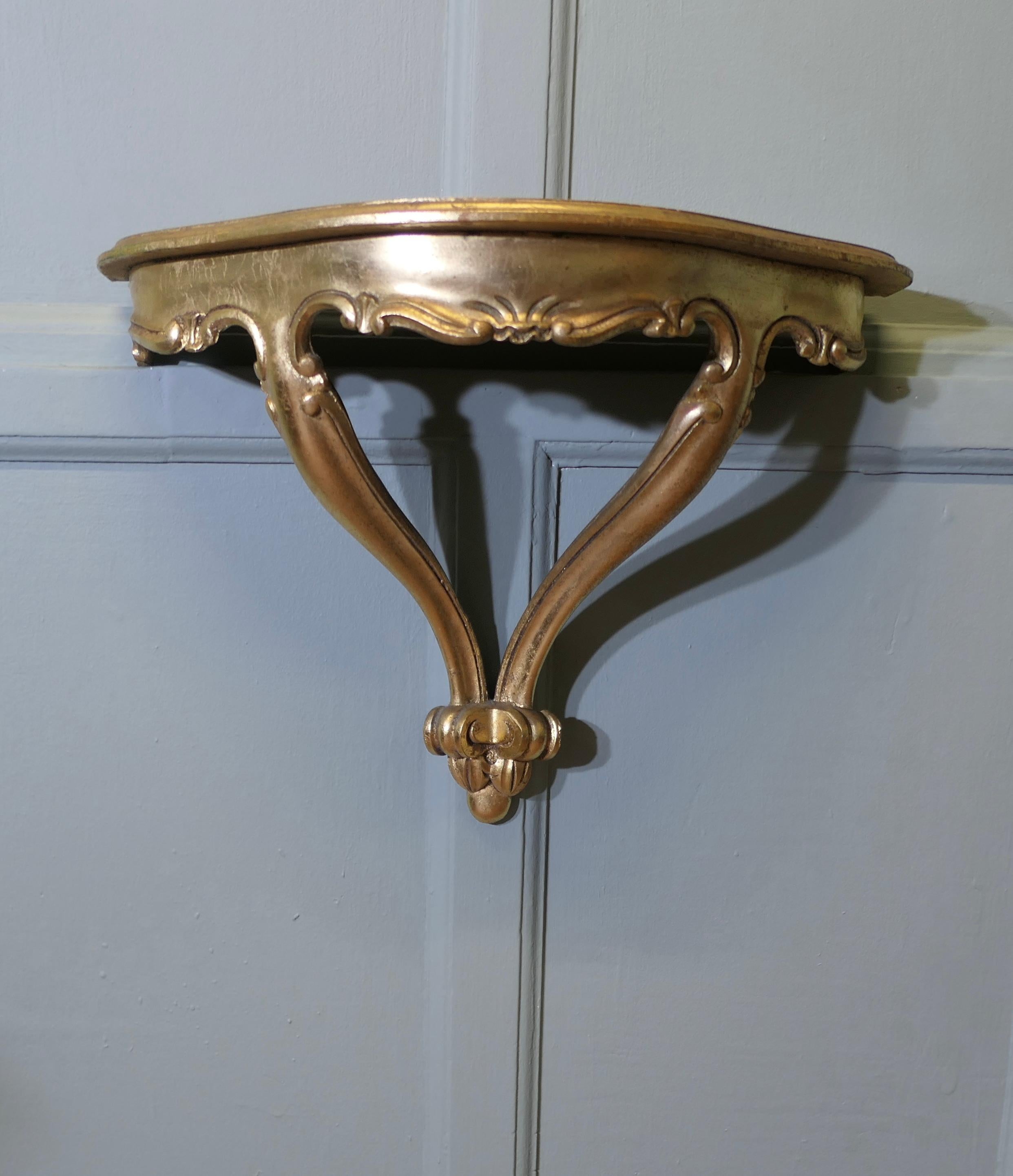 Charming French Gilt Console Hall Table, Wall Shelf

A beautiful gilt console table or shelf, this is a dainty little piece, it fixes to the wall by means of brackets this cannot be seen when assembled and will enhance any hall mirror

The shelf is