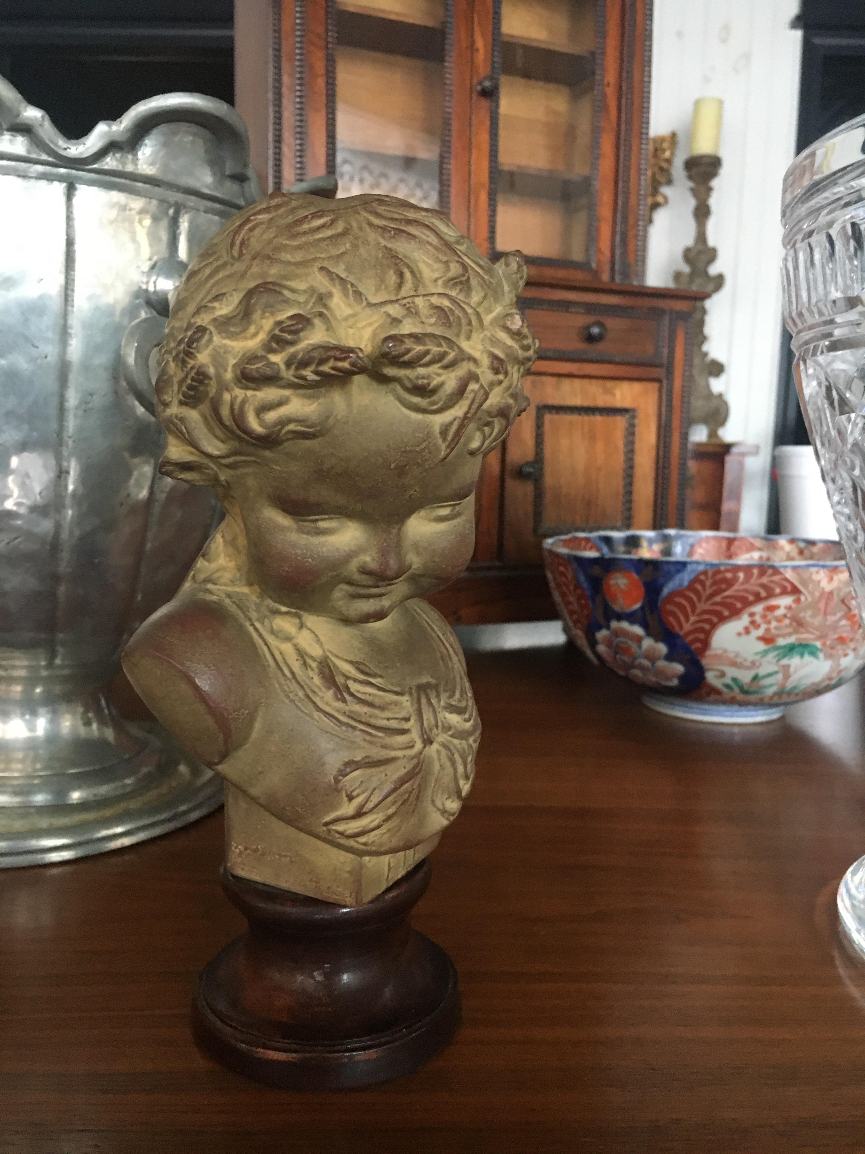 Charming French Terracotta Bust on Ebonized Wood Base Depicting Young Child.  We also have other bust of various subject.  Feel free to call with further questions.