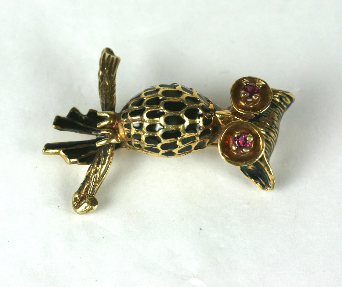 Charming Gold and Enamel Owl in 14k gold with ruby eyes. Black enamel highlights throughout, with the owl perched on a branch. 1960's USA.  1.5