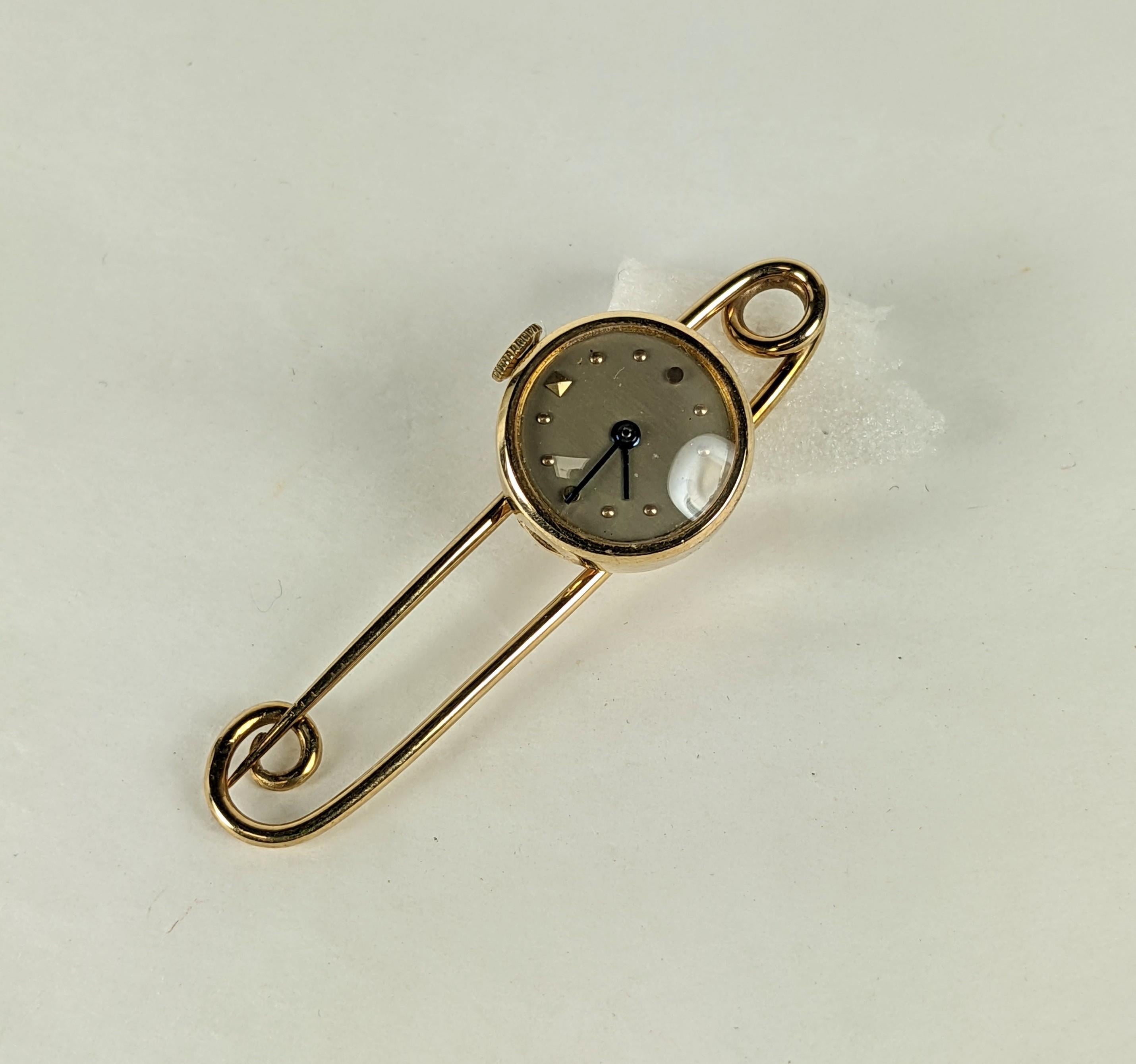Charming Gold Watch Safety Pin set in 14k gold from the 1940's. Great design with watch that swivels from the safety pin for easy viewing. The safety pin is made with one gold wire that forms an elegant self closure. Super versatile and great for a