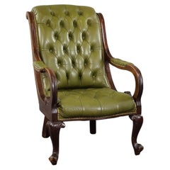 Charming green Chesterfield button seat armchair made of cowhide leather