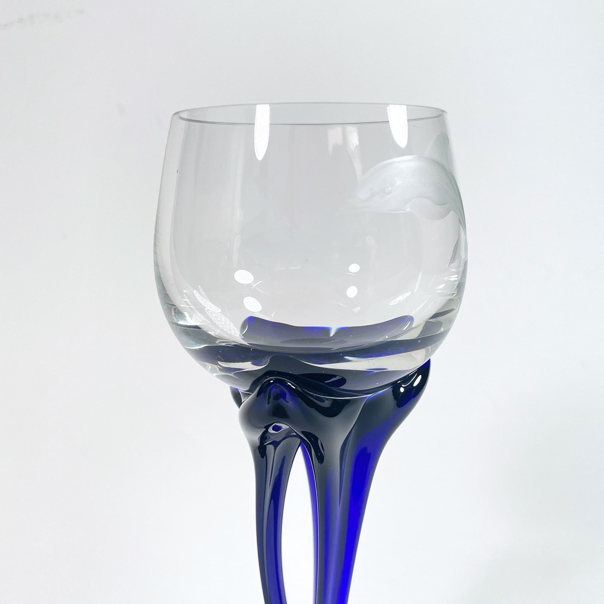 Elevate your dining experience with this enchanting set of five small wine glasses, each meticulously hand-engraved with a delightful dolphin motif. Crafted in the 1990s from exquisite Murano glass, these pieces are a testament to the exceptional
