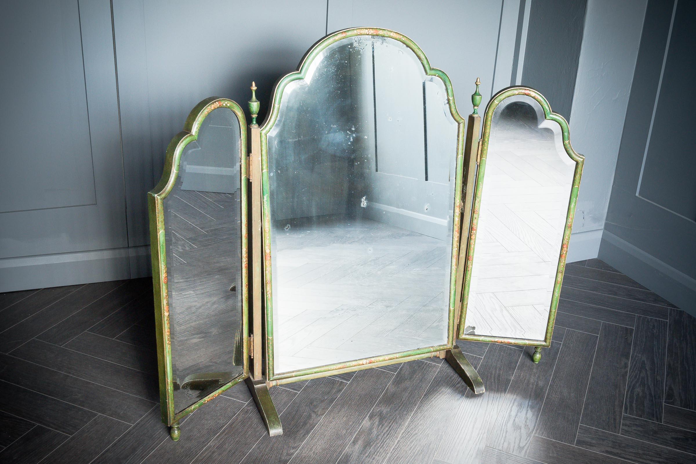 This stunning vanity mirror is charmingly washed in green paint showing different tones and depths throughout the paintwork. The floral design is hand painted over the top. This piece is completed by three individual mirror parts all connected by