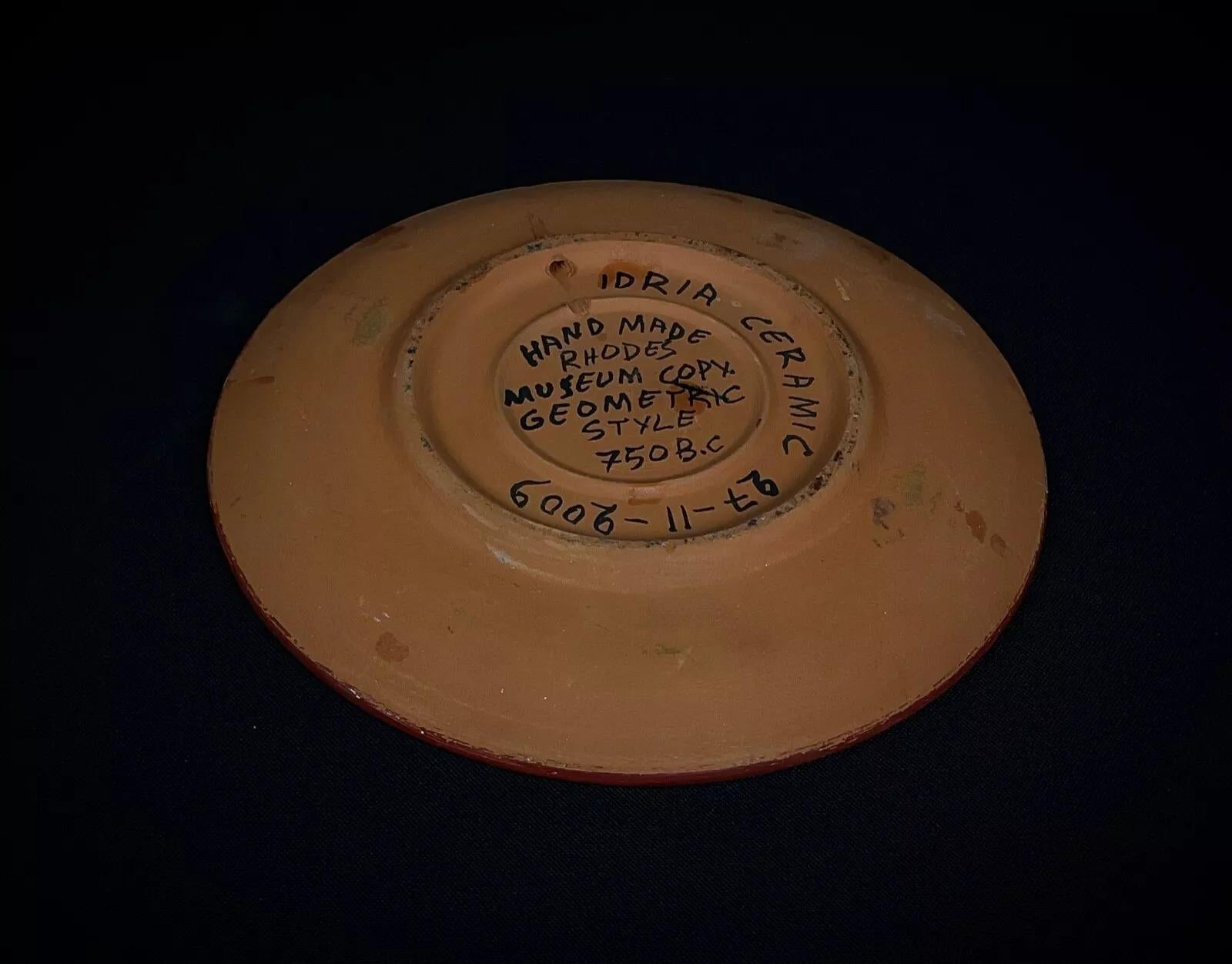 This beautifully crafted ceramic plate is a handmade Rhodes Museum replica inspired by the intricate geometric styles of 750 B.C. Its elegant design makes it both a decorative display piece and a unique addition to any historical or art-inspired