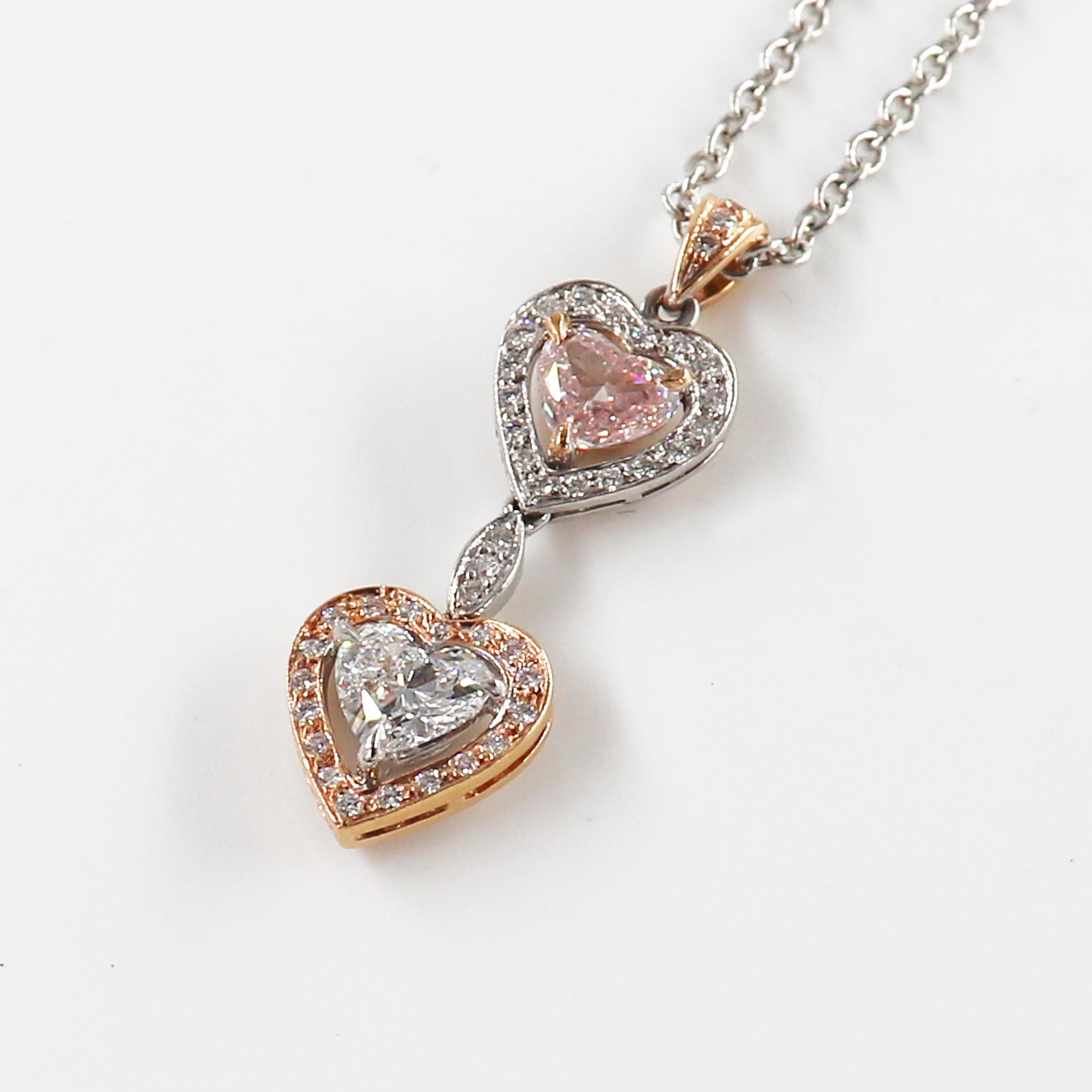 This White Gold Necklace features a delicious Pendant with two heart-shaped Diamonds, one white and the other pink, each weighing 0.80 carat. Those delicate heart-shaped Diamonds are flanked by a bright-cut pave for a total weight of 0.28 carat.