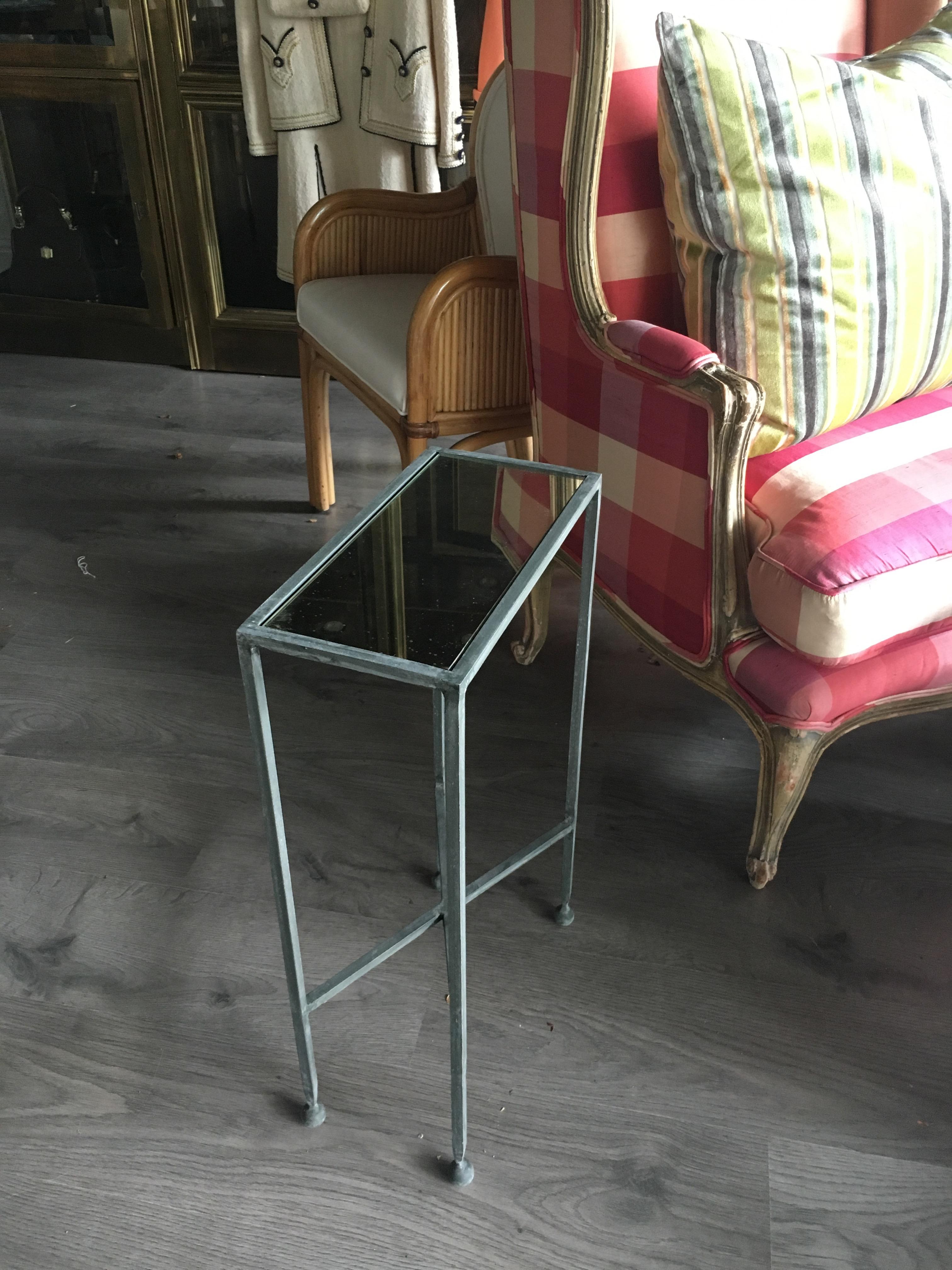 Two charming iron and antiqued mirror Hollywood Regency drinks table. Lovely zinc finish.  Priced per table.