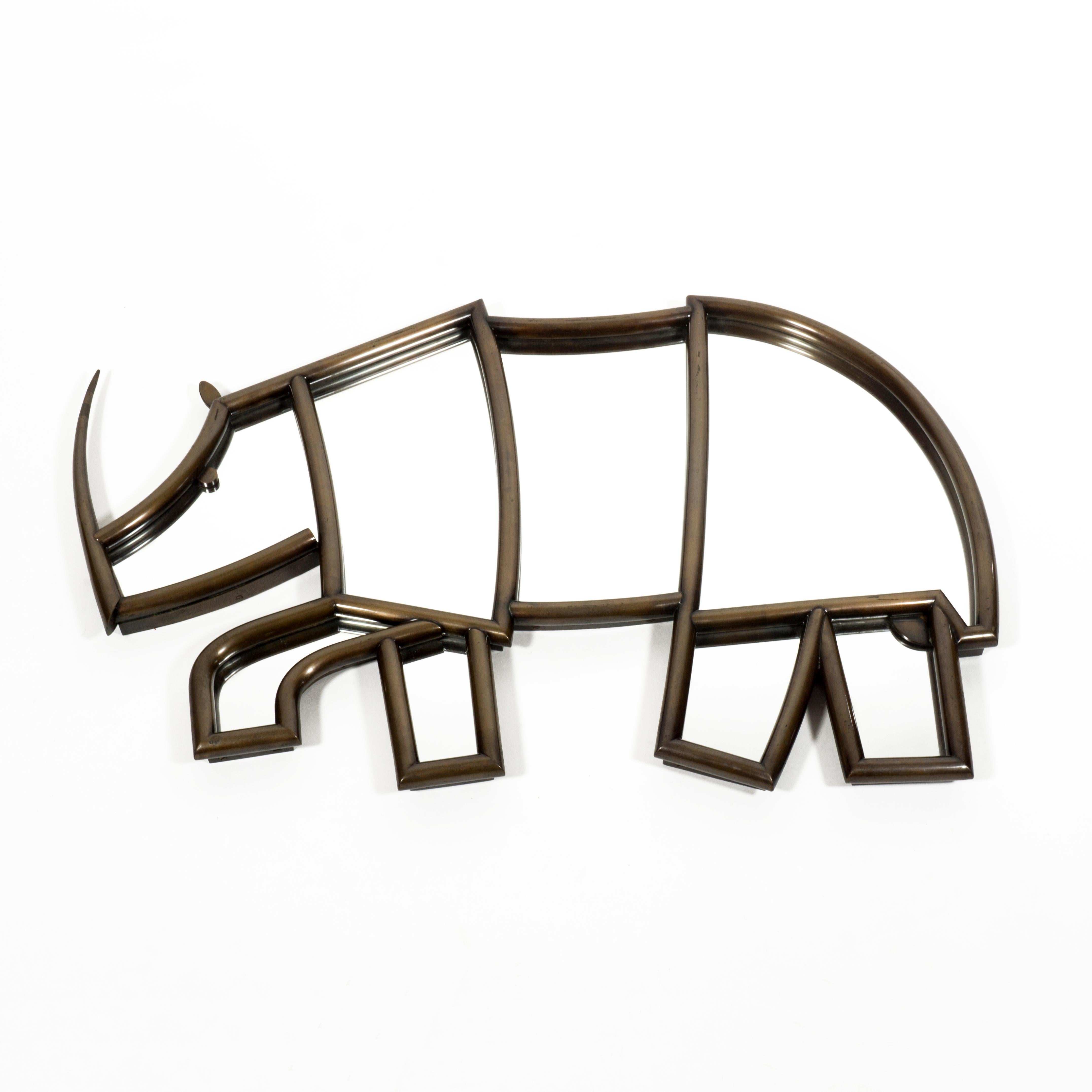 Highly decorative and very charming Italian Wall Mirror in shape of an Rhino from the 1950s.
The front part of the mirror has a beautiful frame made of bronze tubing and is very well crafted. Very special in particular is the beautitully tapered