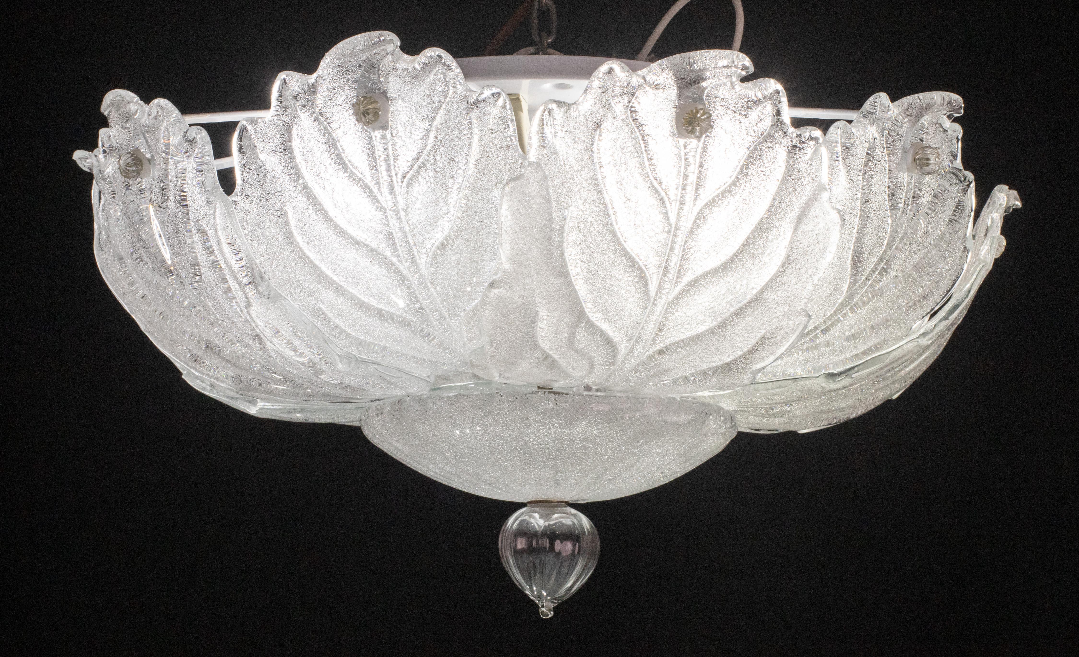 Splendid Murano glass ceiling lamp.

Period: circa 1970.

The light mounts 4 standard European e27 lamp holders, possible rewire for Usa.

Perfect for decorating a large space.

Height measures 35 centimeters from the ceiling, diameter about 60