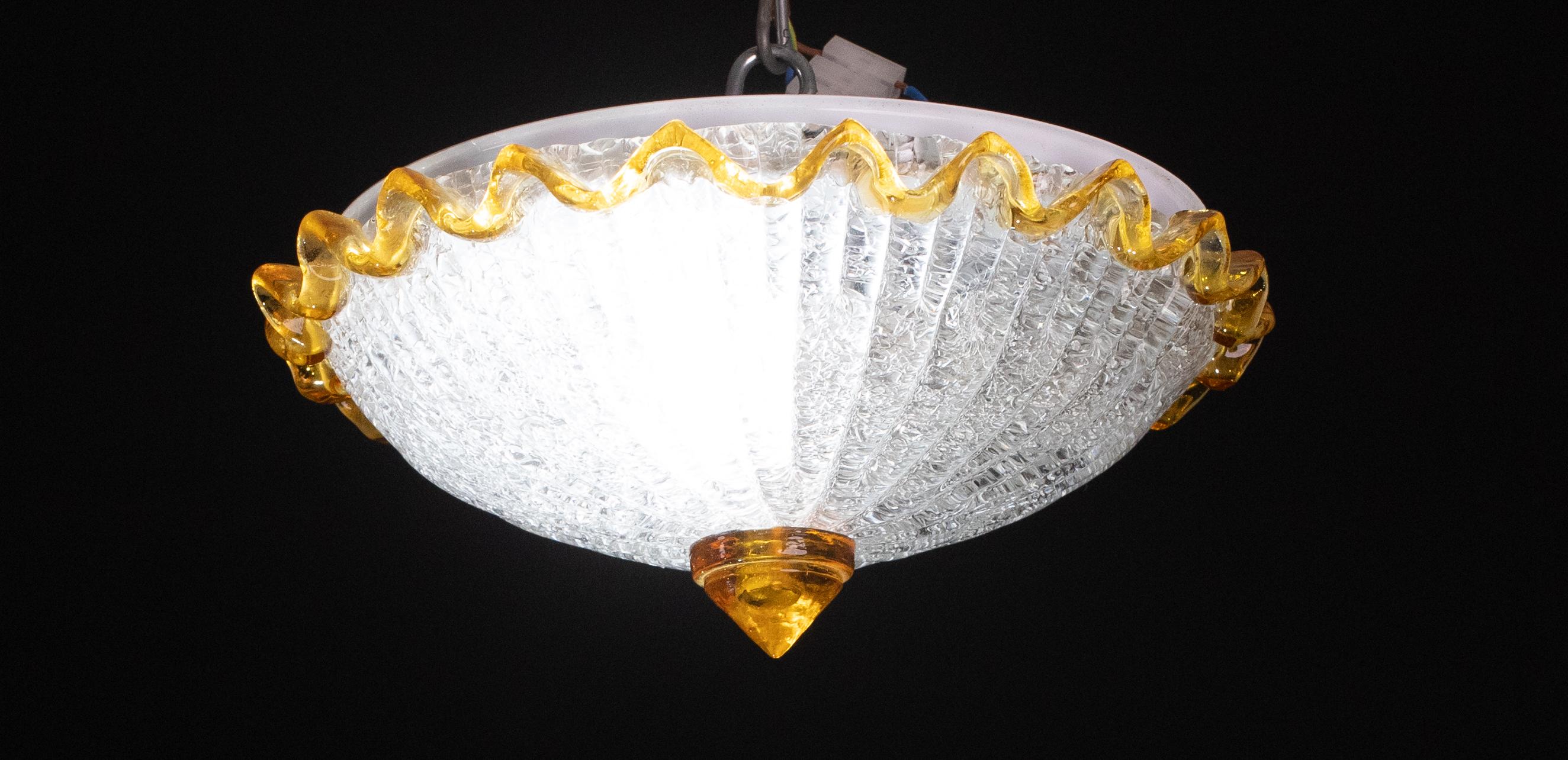 Stunning orange and transparentMurano ceiling light.
The ceiling light consists of two glass elements, the central plate plus the orange low element.
The central plate is surrounded by a wavy orange stripe typical of Venetian\Murano workmanship.
The