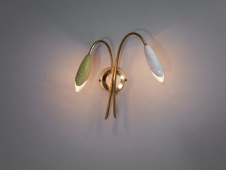 Wall light, brass, aluminum, Italy, 1950s

This atmospheric light comes with diverging curved arms with light shades that resemble the shape of a tulip. This spatial arrangement ensures that the light is evenly divided. The perforated shades shows