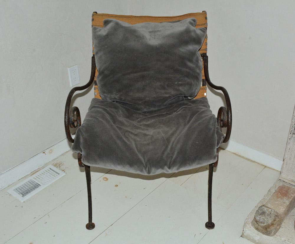 Antique iron metal base lounge chair with scrolled arm and loose cushions and webbing support. Extremely comfortable and inviting. 
Measures: Arm height 25