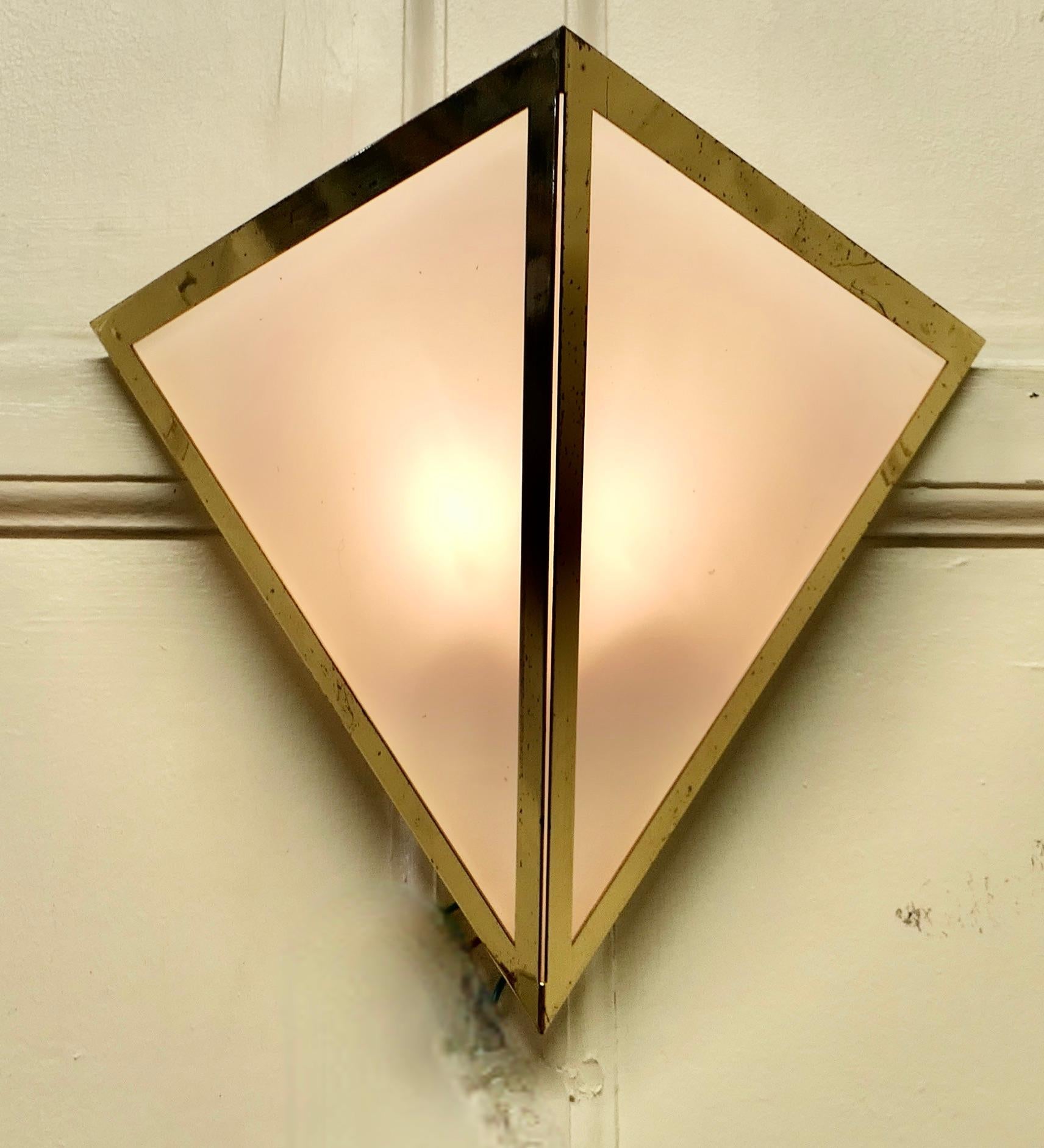 Charming Mid Century French brass wall light

This very attractive piece, it is in the shape of a Pyramid, the frame is brass and it is infilled with opalescent glass to reflect maximum light
The wiring is recent and looks fine but will need to