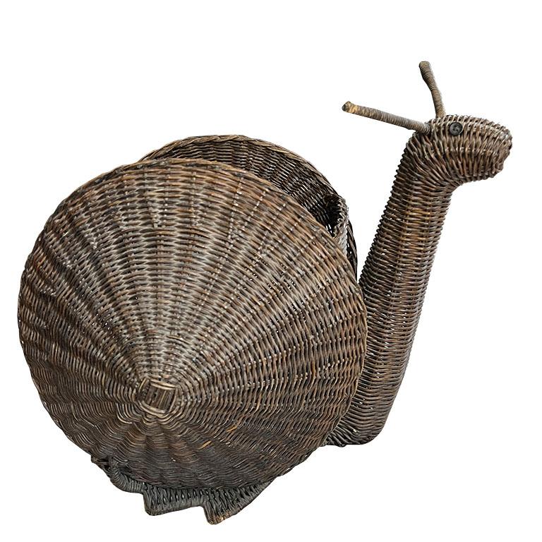 A delightful fusion of whimsical design and masterful craftsmanship, this mid-century French wicker snail basket is a rare and collectible piece that brings a touch of natural elegance to any space. Handwoven from richly patinated rattan, the