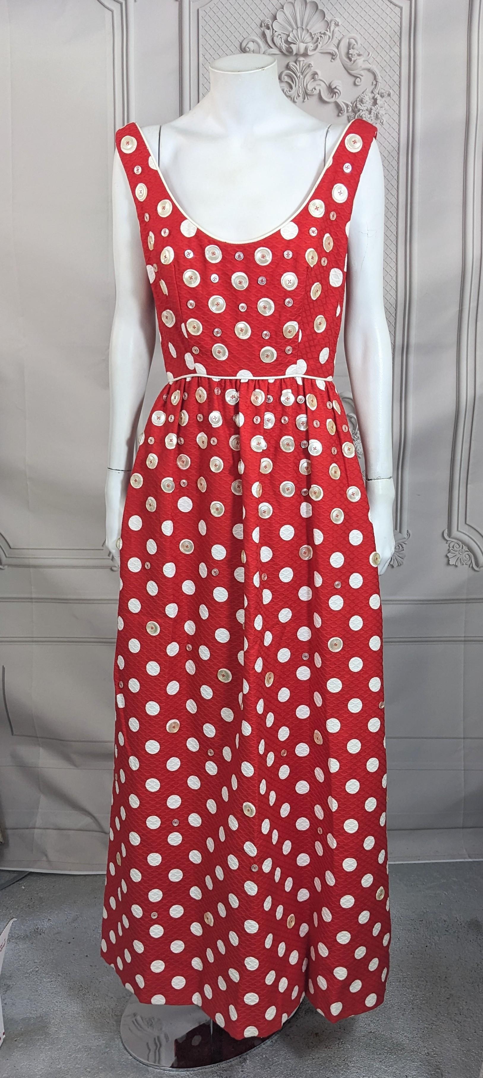 Charming Mod Button Decorated Maxi from the 1960's of cotton quilted matelasse with applied plastic buttons throughout. Wide set straps with empire waist, and full gathered skirt to floor. Most of the faux mother of pearl decorative buttons are
