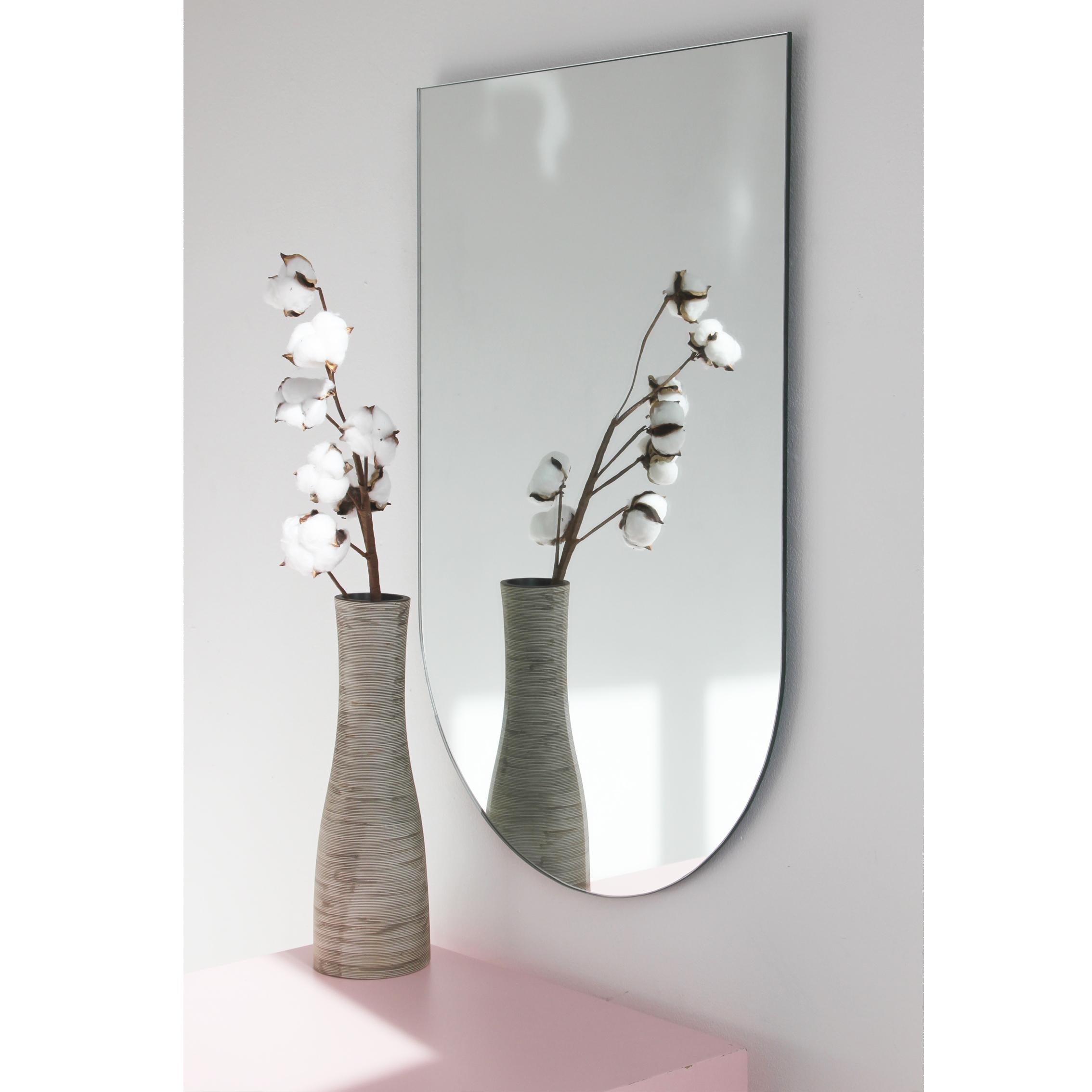Minimalist arch shaped frameless mirror that can be hung in 4 different positions. Quality design that ensures the mirror sits perfectly parallel to the wall. Designed and made in London, UK.

Fitted with professional plates not visible once