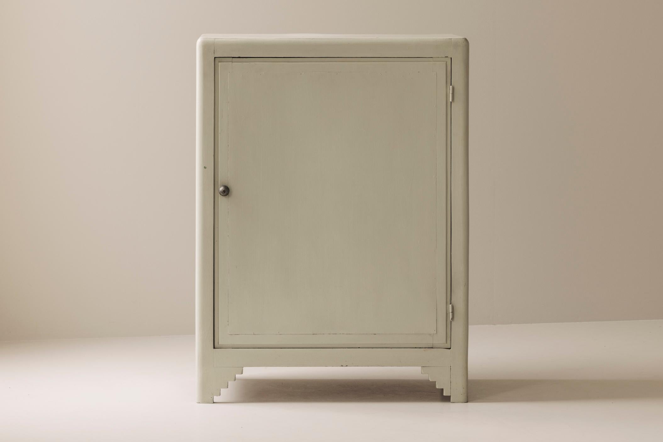 A charming Modernist French cabinet from the 1950s, showcasing simple elegance and well-balanced proportions. Painted in a soft, neutral tone, the piece exudes understated character while maintaining versatility for a range of interiors. The cabinet