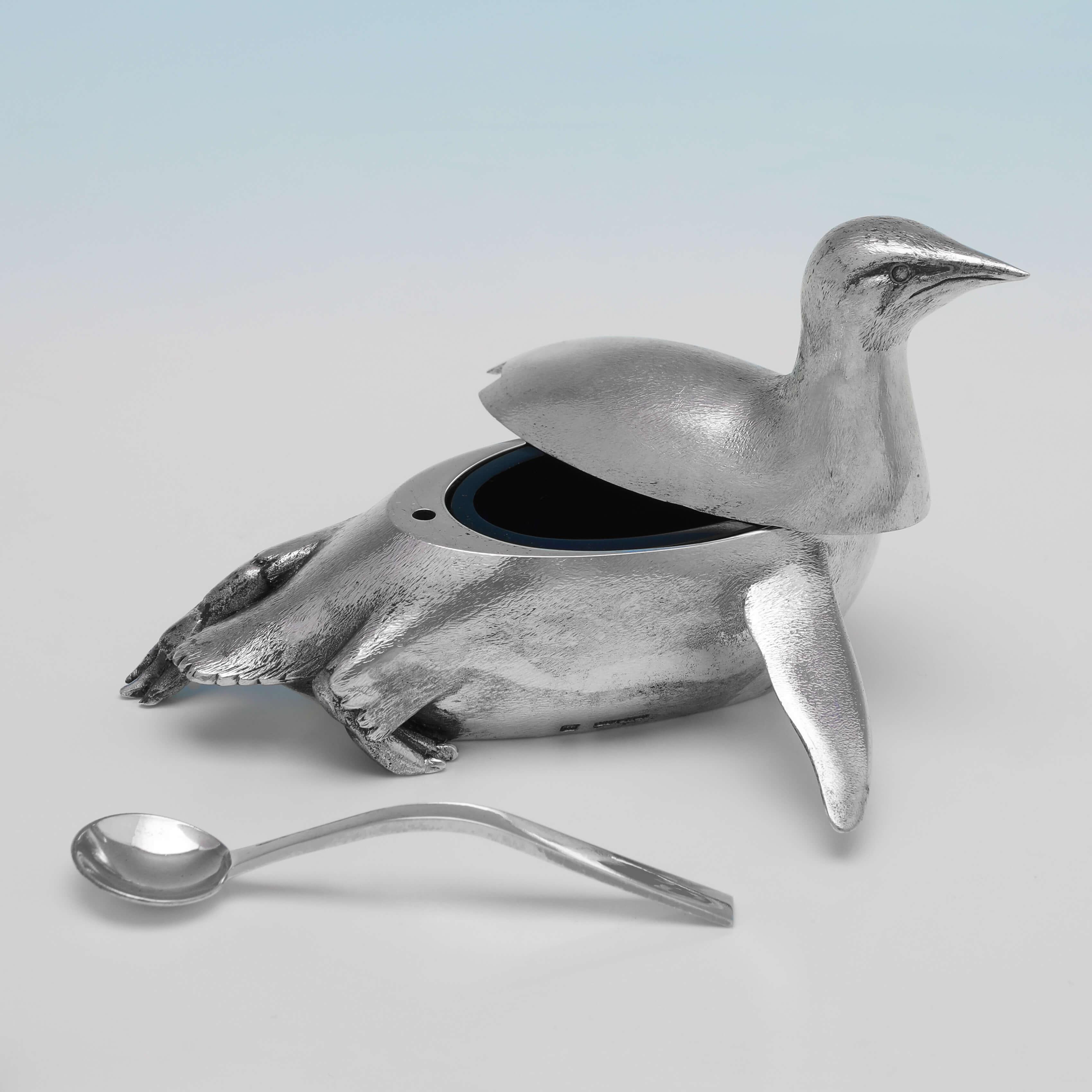 Hallmarked in London in 1996 by Meiling & Gartrell, this wonderful, and very charming, sterling silver condiment set, is modelled to resemble Emperor Penguins. The taller penguin (the salt) measures 3.75